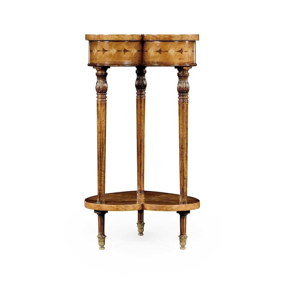 Sheraton inspired finely inlaid lamp table with a heart-shaped lidded top and under tier of classical motifs. Detailed carving to the three tapered and fluted legs with brass acanthus sabots. The original of circa 1780.

Dimensions: 14