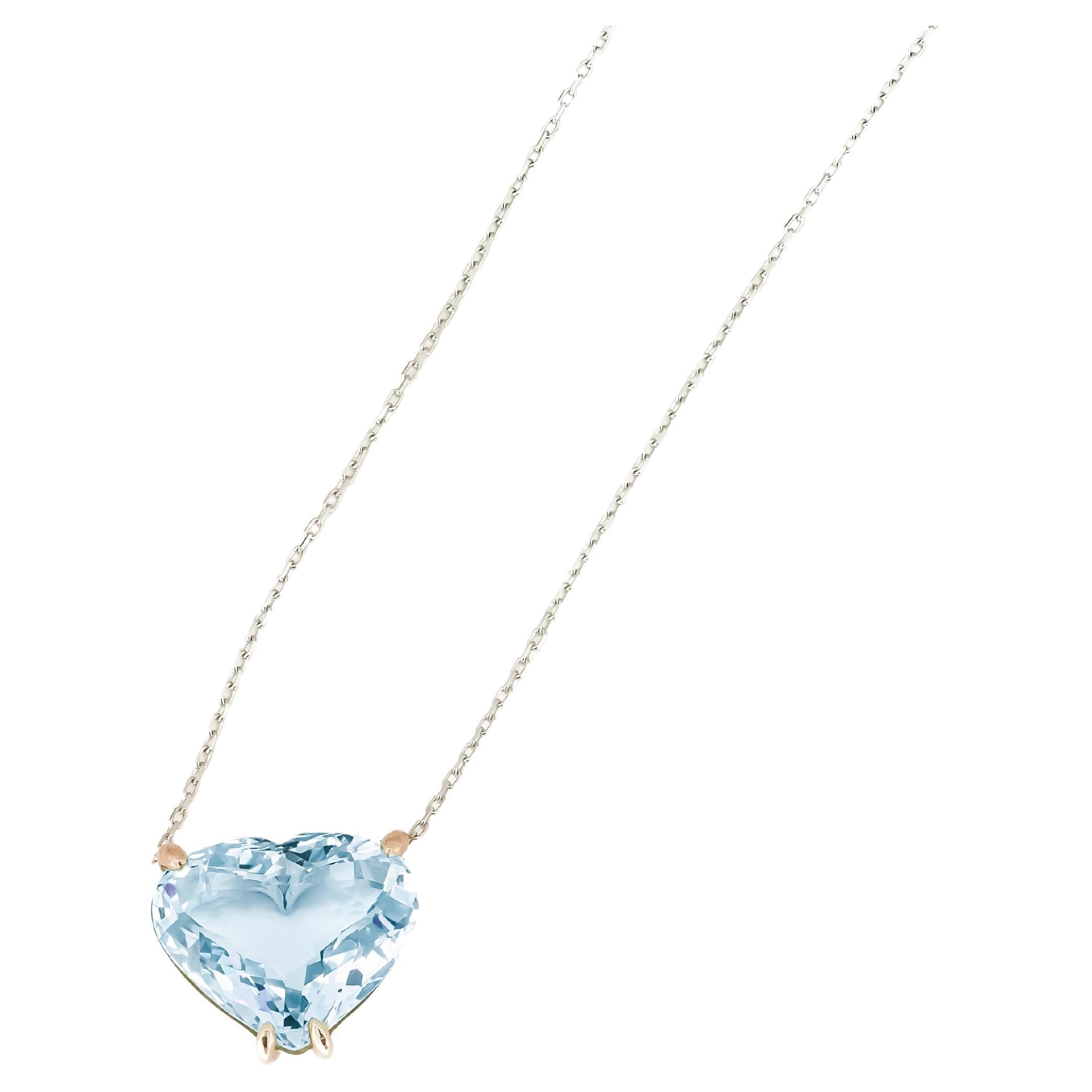 Heart shaped topaz pendant necklace in 14k gold. 