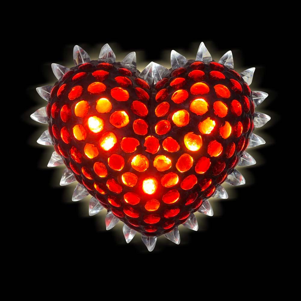 A stunning sculptural art object. Bespoke heart shaped lighting sculpture with red caboshon cut glass and clear glass splinters on a crafted metal frame. Contemporary Italian Design.
A truly must have light.