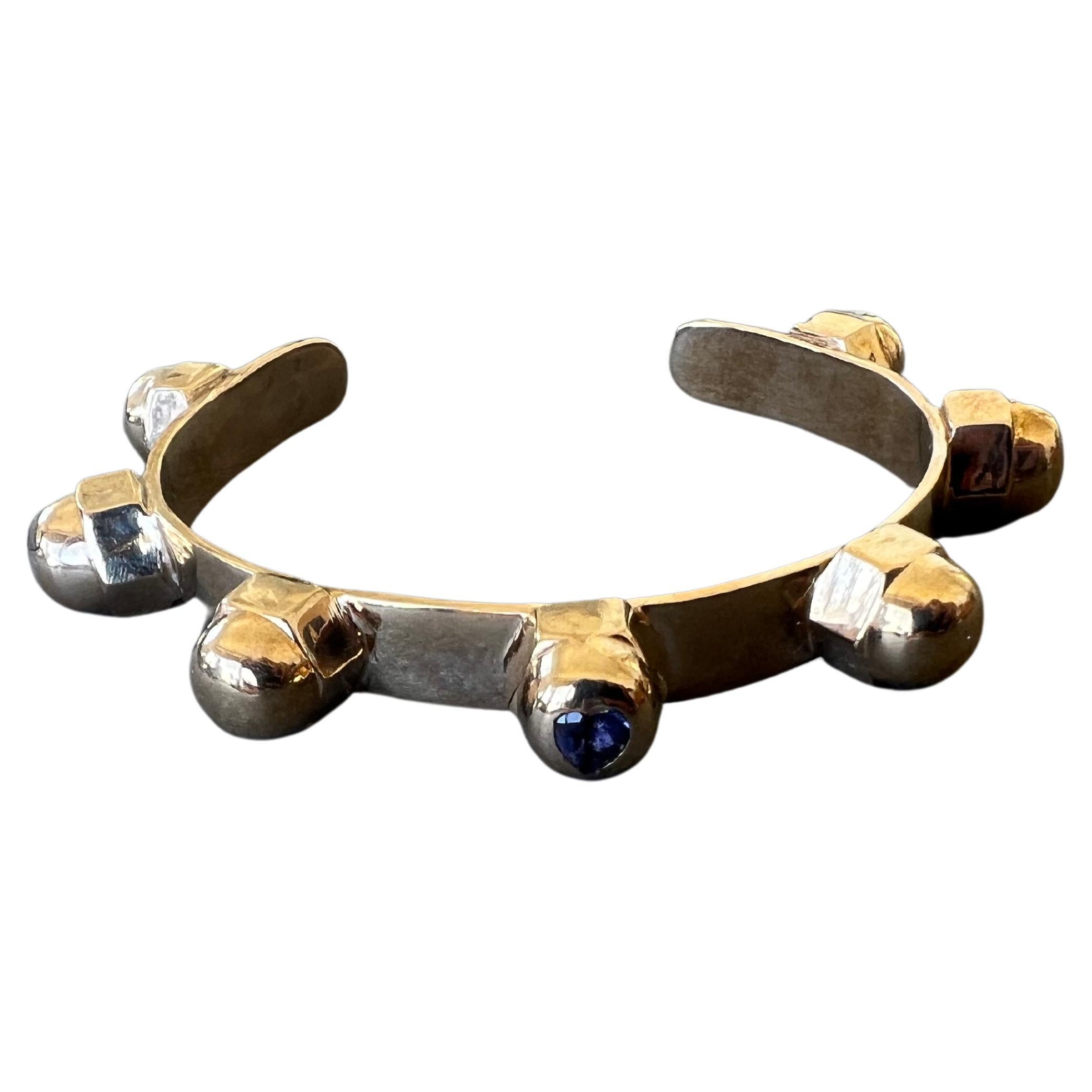 Tanzanite Heart Gem Cuff Bangle Bracelet 7 Studs J Dauphin

Material: Polished Bronze

Size Medium/ Large

Designer: J DAUPHIN 

Tanzanite is a rare gemstone found only in Tanzania and is known for its deep blue color reminiscent of the finest