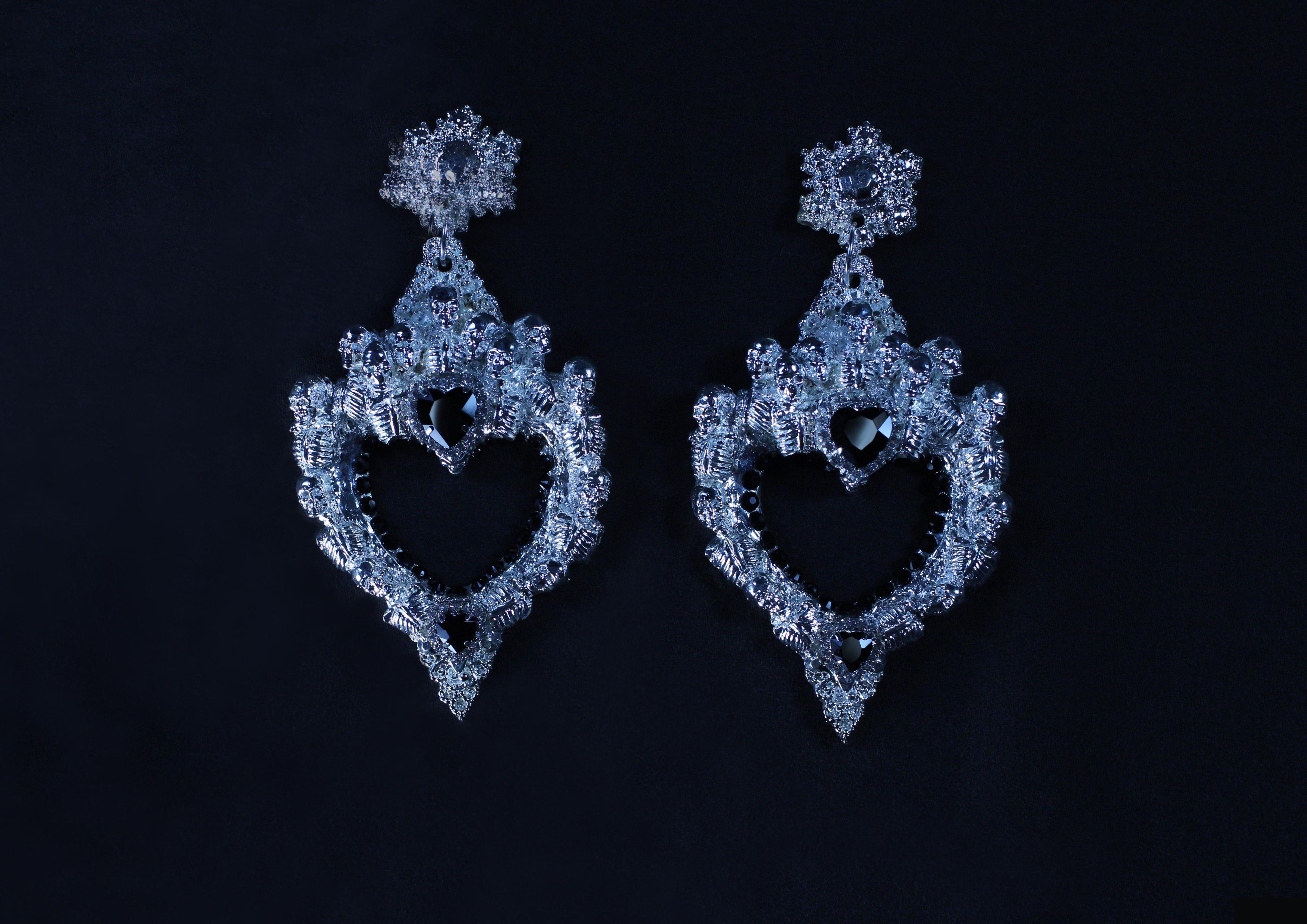Heartbreaker Earrings by Angelis Blade

An homage to the gothic elegance of ancient skull churches, the Heartbreaker earrings are a bold fusion of femininity and edge. Each earring features a heart-shaped hoop design, intricately adorned with