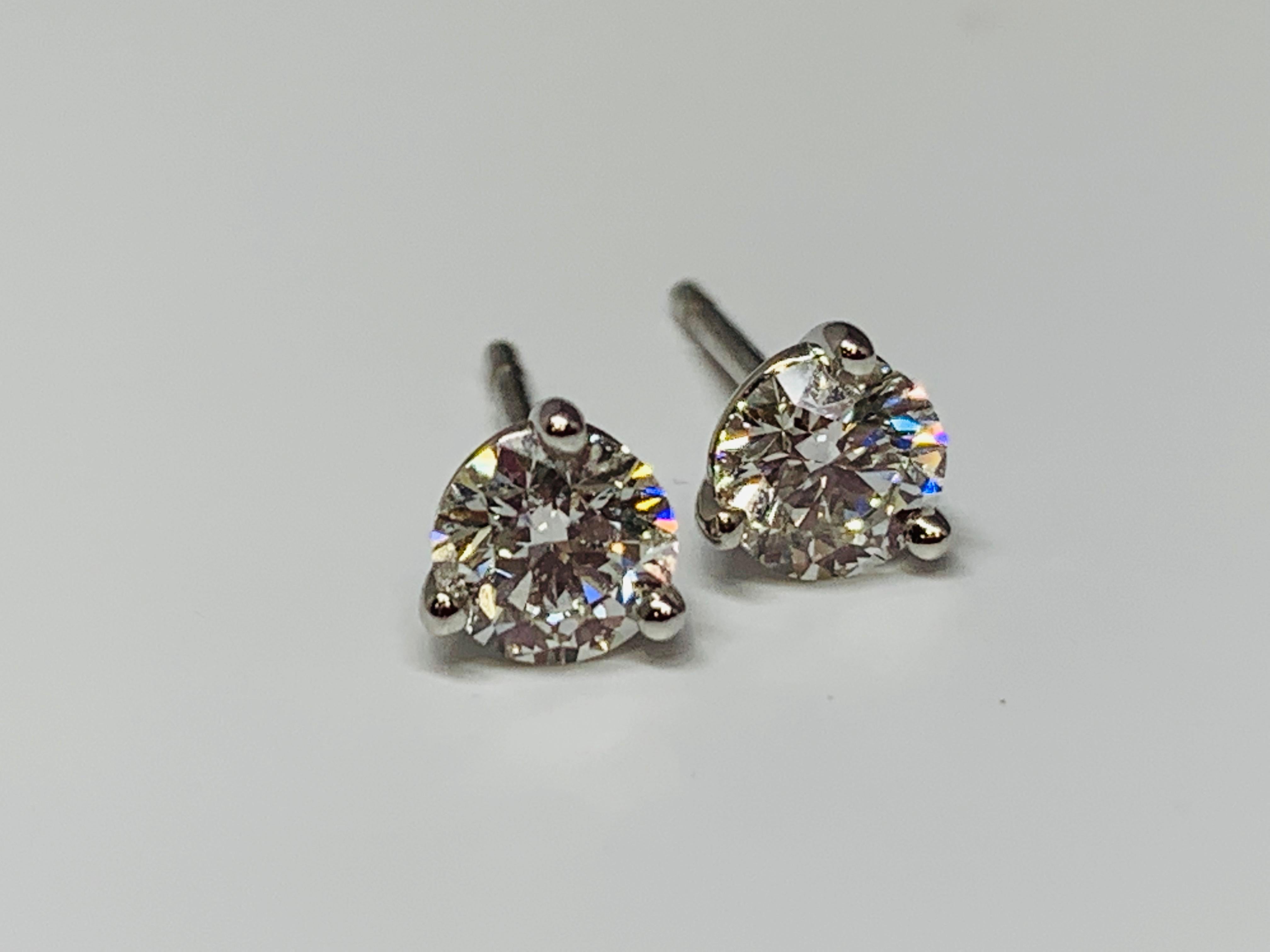 These classic 3-prong martini style stud earrings are the perfect everyday accessory. The 18K white gold mountings hold a 0.51 carat round diamond each. The quality of the stones are approximately G-H/VS-SI. Hearts On Fire diamonds are the world's