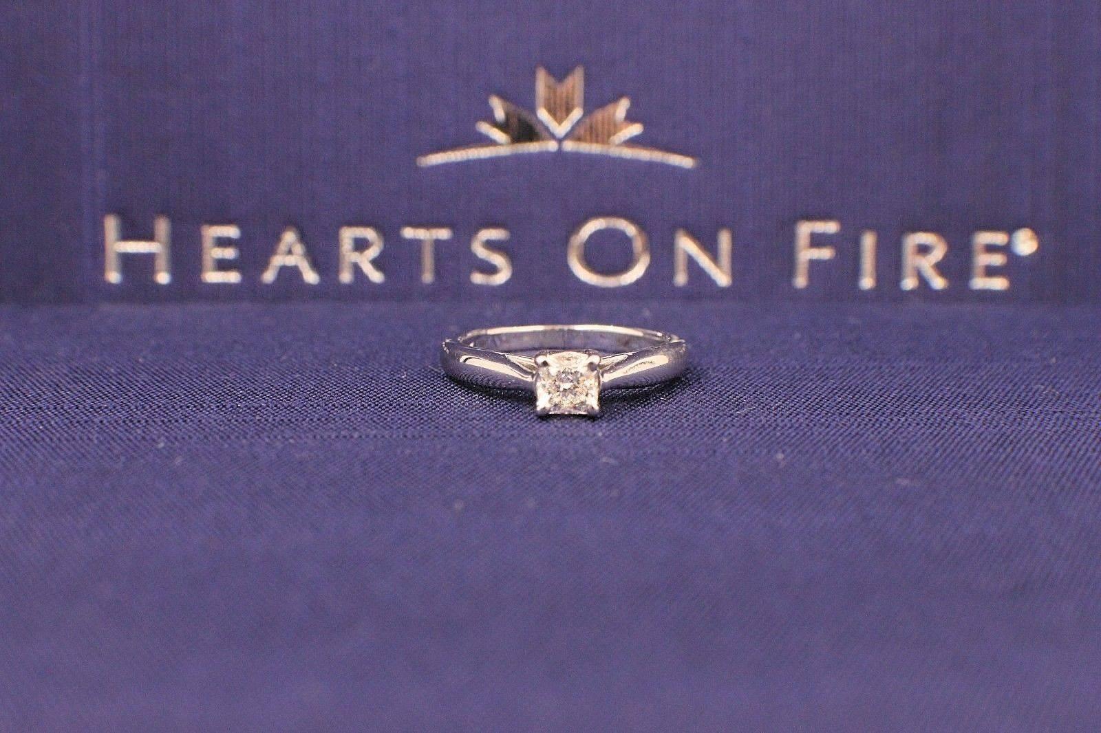Brand:  HEARTS ON FIRE
Style of Setting:  4-Prong Dream Solitaire Engagement Ring
Serial Number:  HOF 8315
Metal:  White Gold 18KT
Size:  4.75 - sizable
Total Carat Weight:  0.44CTS
Color & Clarity:  G - H / VS - SI
Diamond Shape:  HOF DREAM