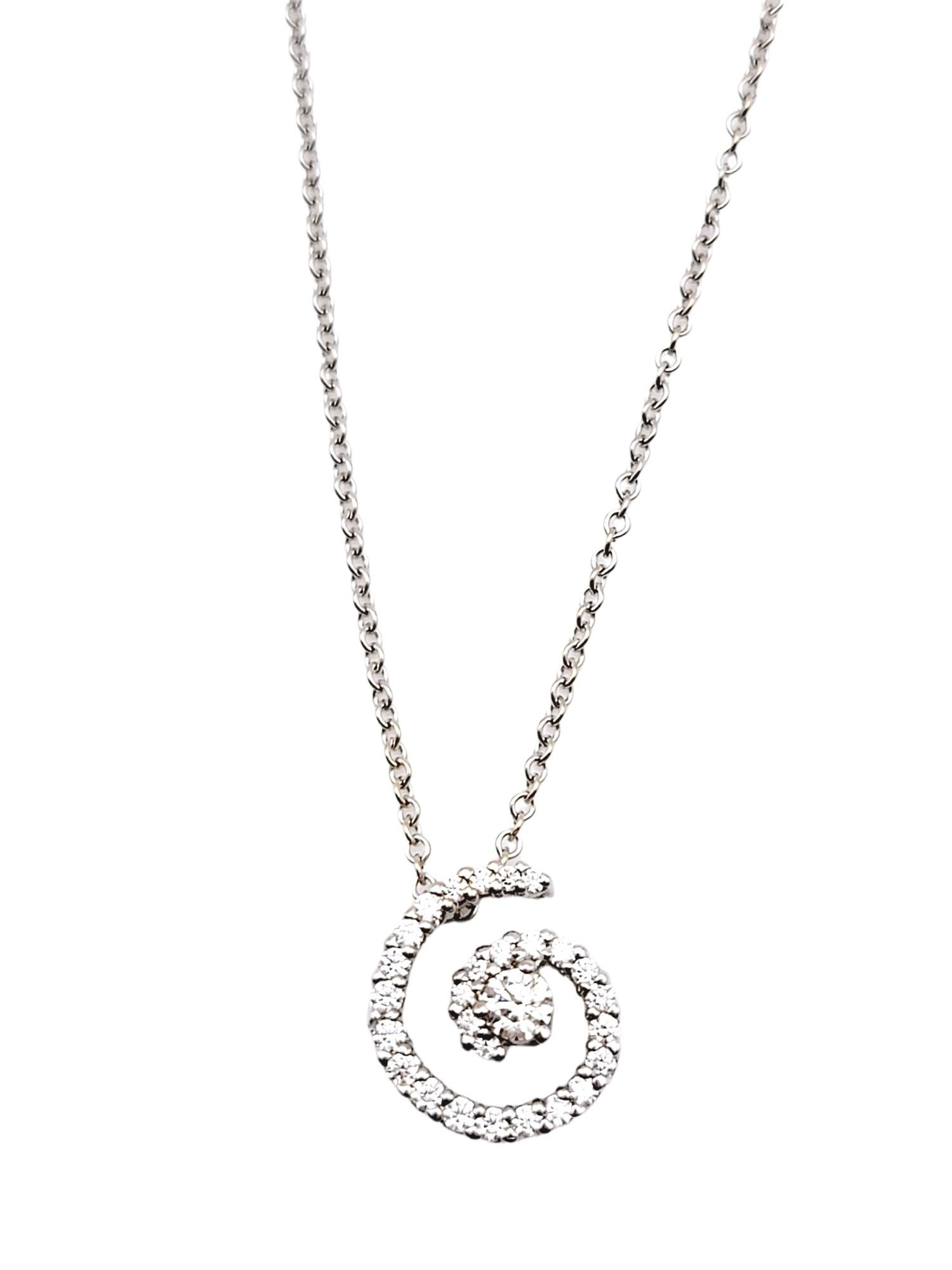 This glittering modern diamond pendant necklace is simple yet chic. The delicate chain and icy spiral of natural round diamonds goes with just about everything. The luxurious 18 karat white gold setting further enhances the white brilliance of the