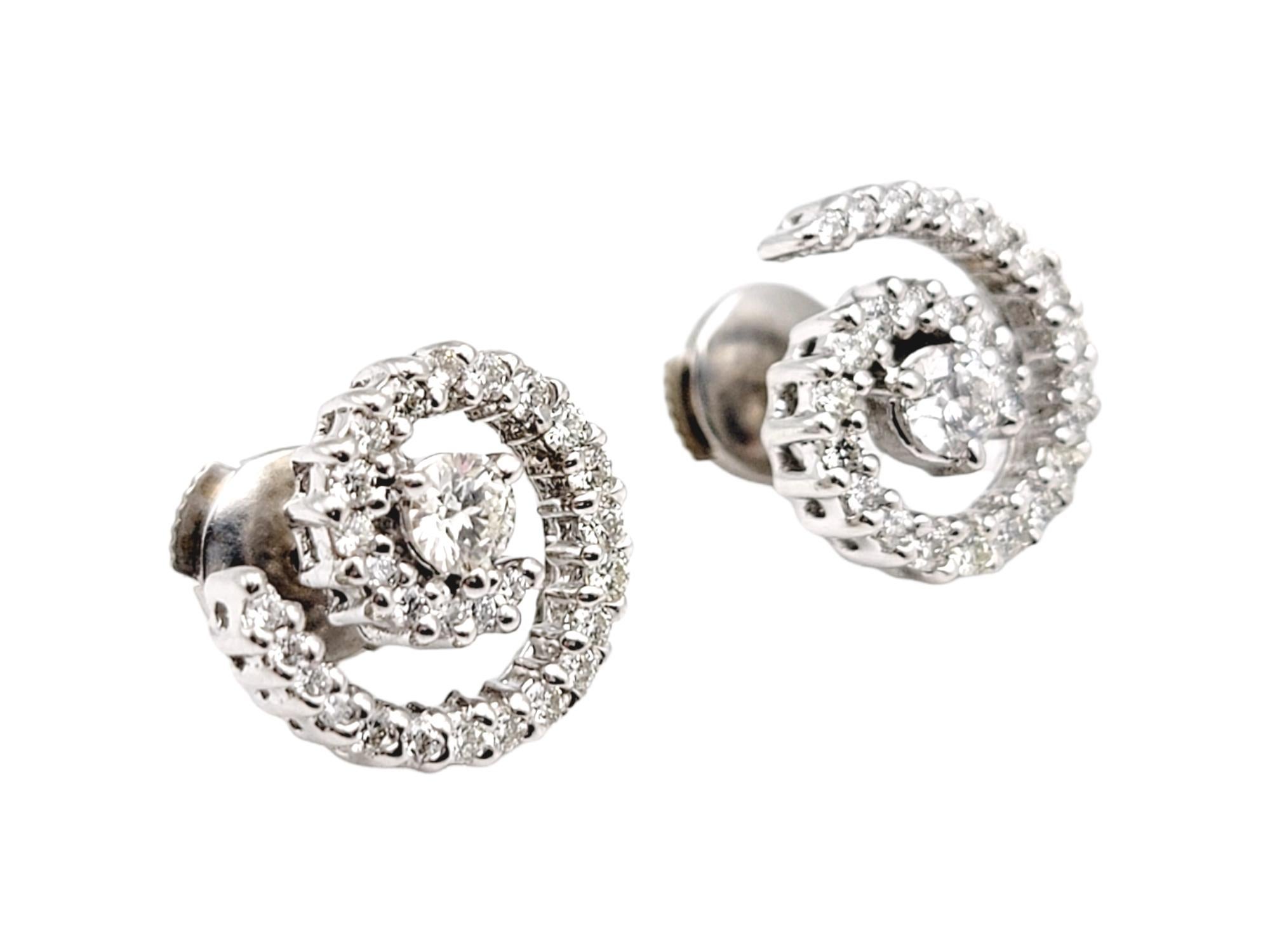 These glittering diamond spiral stud earrings are modern, sparkly and chic. The icy spiral of natural round diamonds goes with just about everything and can be dressed up or down. The luxurious 18 karat white gold setting further enhances the white