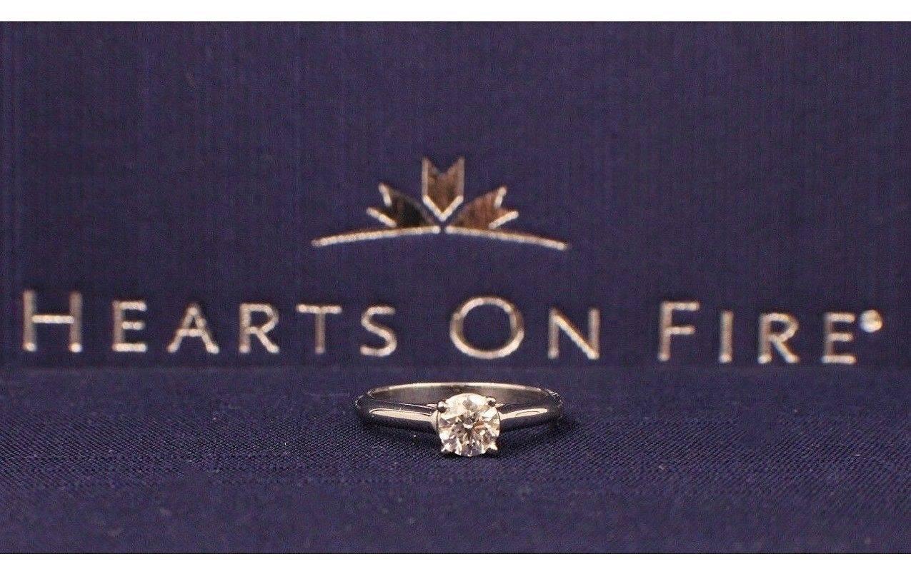 Brand:  HEARTS ON FIRE
Style: Solitaire Engagement Ring
Serial Number:  74083
Metal:  White Gold 14KT
Size: 4.25 - Sizable
Total Carat Weight:  0.446 CTS
Diamond Shape:  Round Brilliant
Diamond Color & Clarity:  G / VS2
Diamond Inscription: