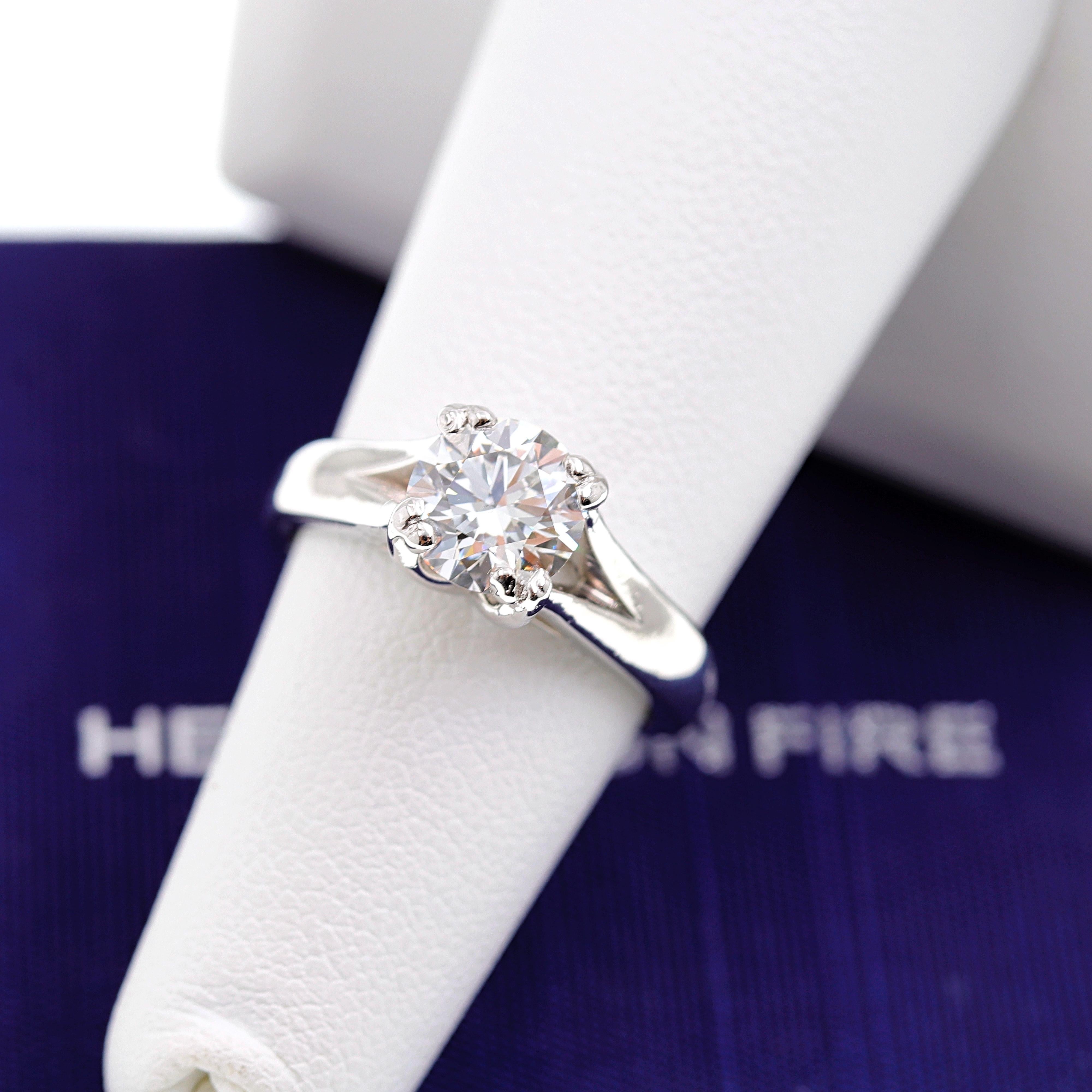 Hearts on Fire Diamond Engagement Ring

Style:  Solitaire
Serial Number:  HOF3018
Certification:  AGS 0008759604
Metal:  PT950
Size:  6 - sizable
Total Carat Weight:  1.310 cts
Diamond Shape:  Round Brilliant
Diamond Color & Clarity:  G -