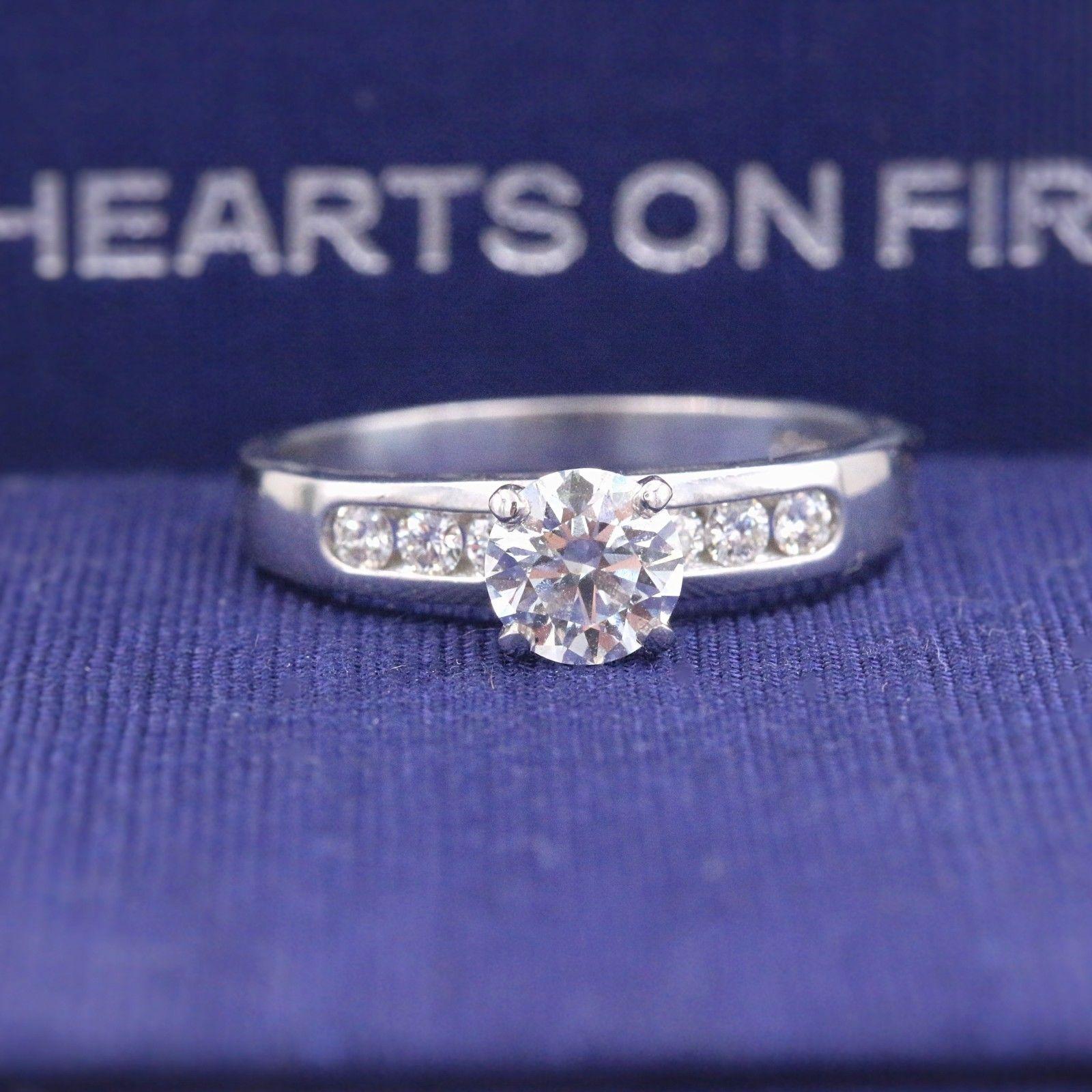 HEARTS ON FIRE
Style:  Seven-Stone Diamond Engagement Ring
Metal:  18k White Gold with Platinum Prongs
Size:  6.75 - sizable
Total Carat Weight:  0.795 tcw
Diamond Shape:  Round Brilliant Diamond 0.615 cts
Diamond Color & Clarity:  I / VS2
Accent