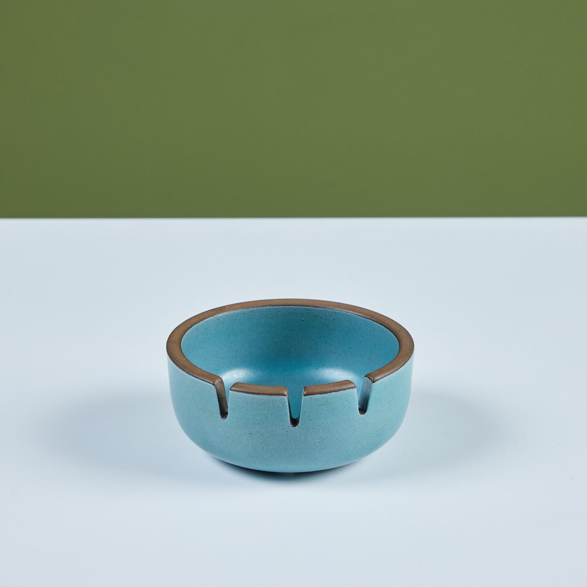 Glazed ceramic ashtray by Heath Ceramics, c.1960s, USA. The ashtray features a blue exterior and interior glaze. There are three holding slots for cigarettes. Can also be used as a decorative catchall or soap dish.
Inscribed on the underside, “Heath