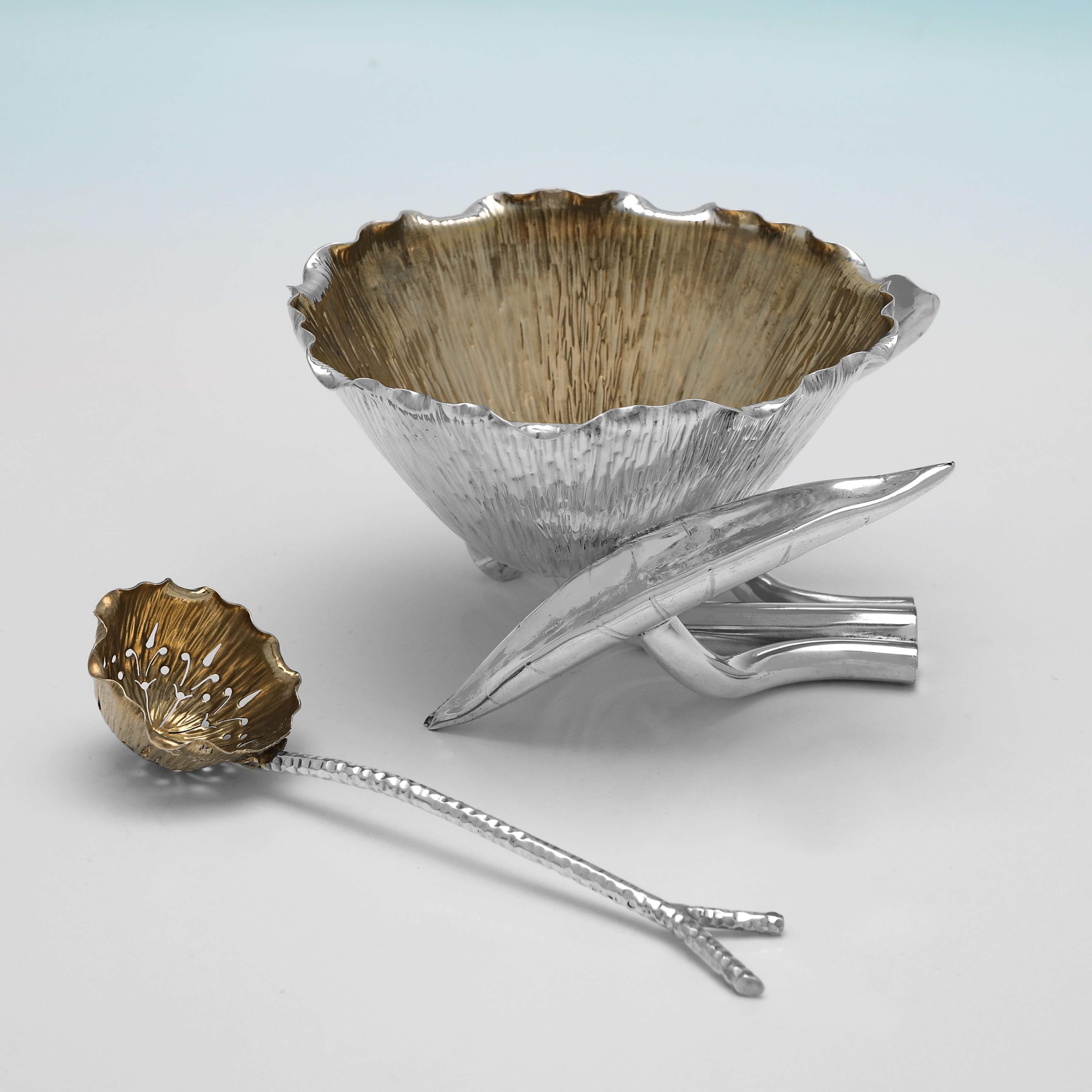 Hallmarked in London in 1902 by Heath & Middleton, this wonderfully designed Antique Sterling Silver Sugar Bowl, takes the form of a blossoming lotus flower, supported on the stems of two curled leaves, and accompanied by a sugar sifter spoon with a