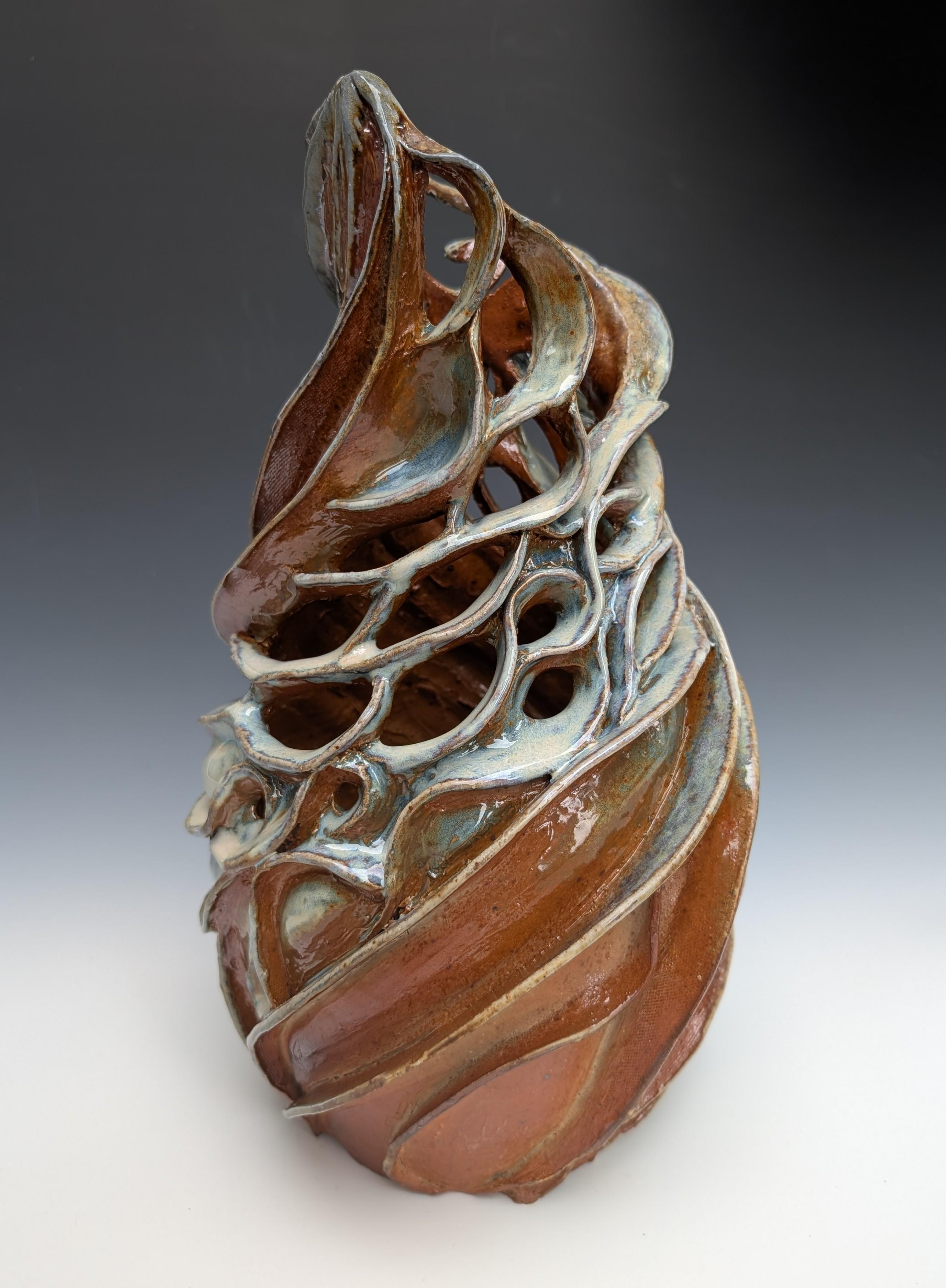 Heather Binder's "Long Pond" is a contemporary wood fired ceramic sculpture depicting the artists interpretation of gentle ripples reflected on the surface of Long Pond in New Hampshire. This 15 x 8 x 8 inch sculpture is partially glazed in soft