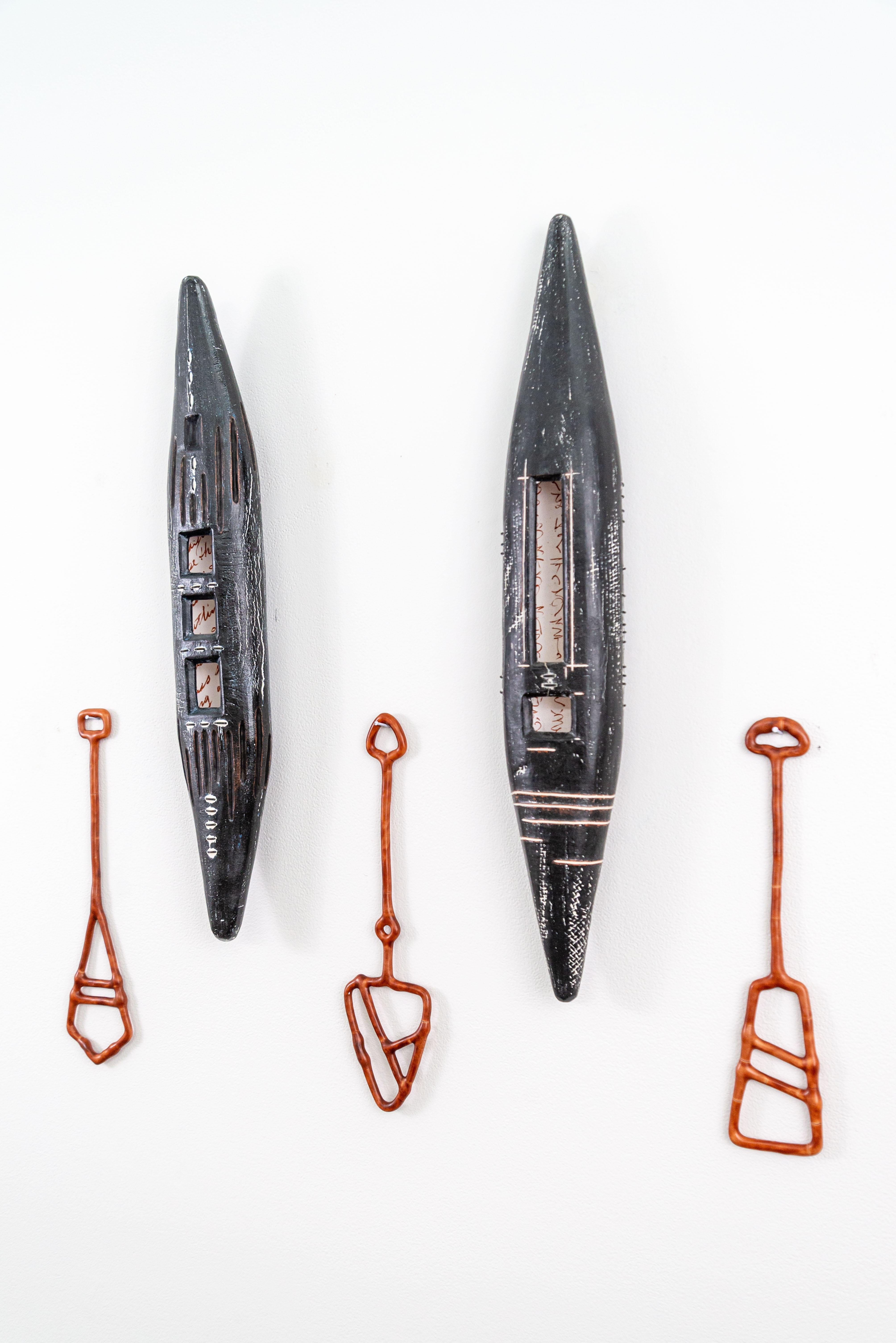 Heather Allen Hietala’s mixed media art is designed to tell a story. The American artist uses the vessel as a metaphor for life’s journey. Hietala hand-builds ceramic canoe-like shapes—this diptych (two pieces) rendered in black with white markings