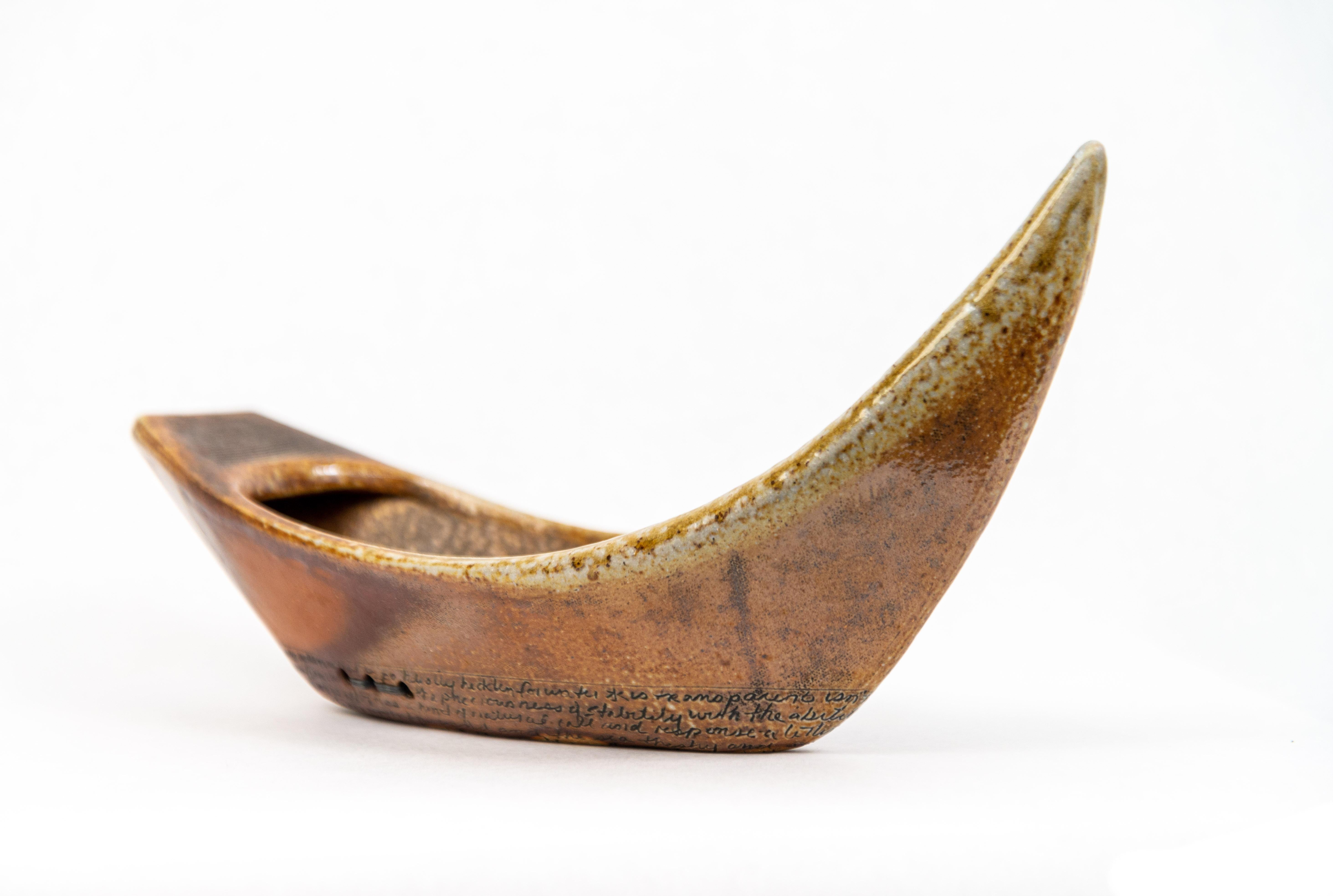 For American artist Heather Allen Hietala, the hand-built clay vessels she’s created symbolize the mystery of life’s journey. Rendered in a gorgeous earthy palette, this piece features a larger vessel with a smaller one lashed to its interior.