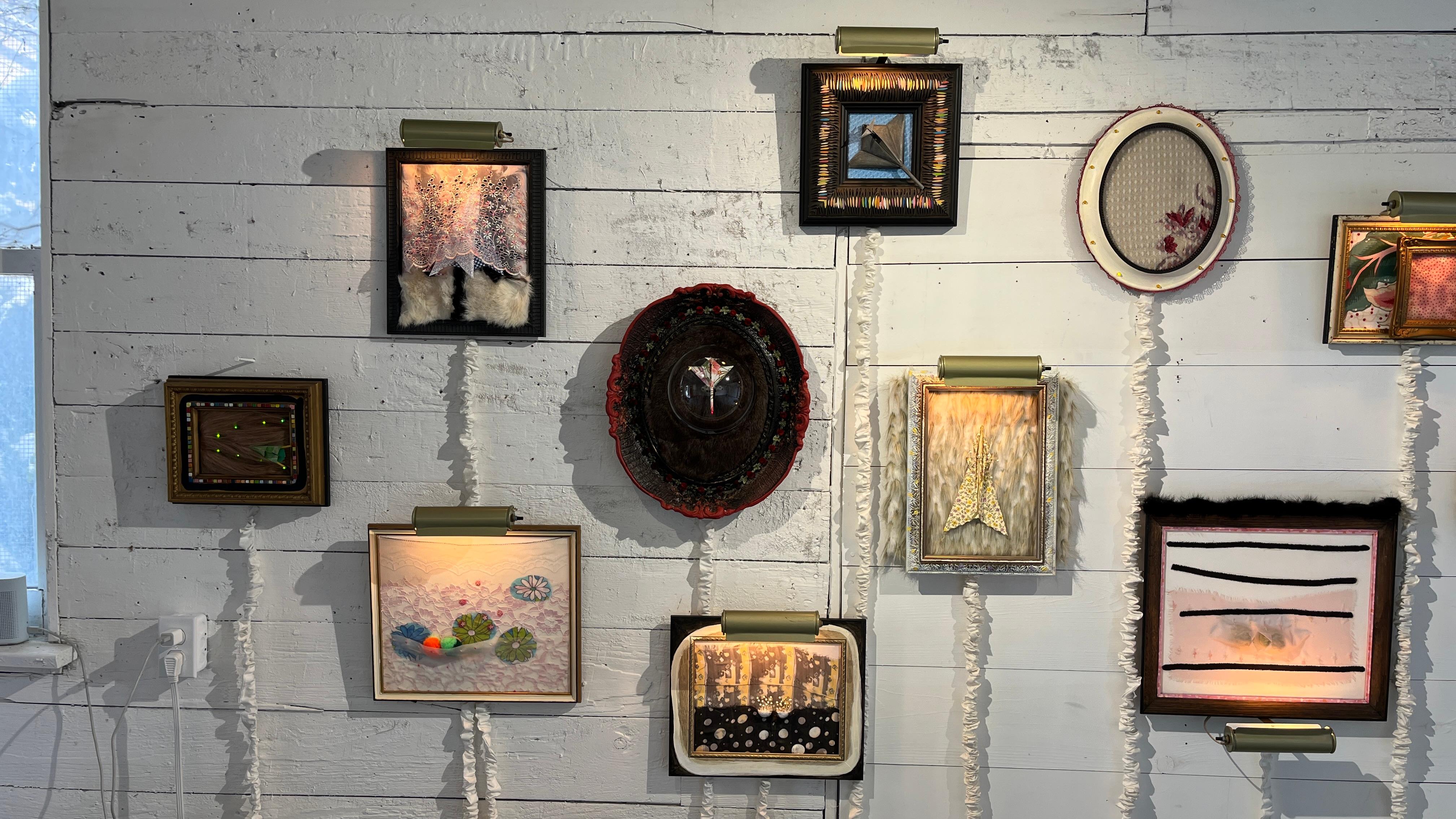 “Specimen“ is a mixed media piece by artist Heather Nicol, and measures 16x13x3“. Part of a body of work known as Salon, this particular assemblage is comprised of frame, faux fur, paper, pins and electric picture light, on board. The artist