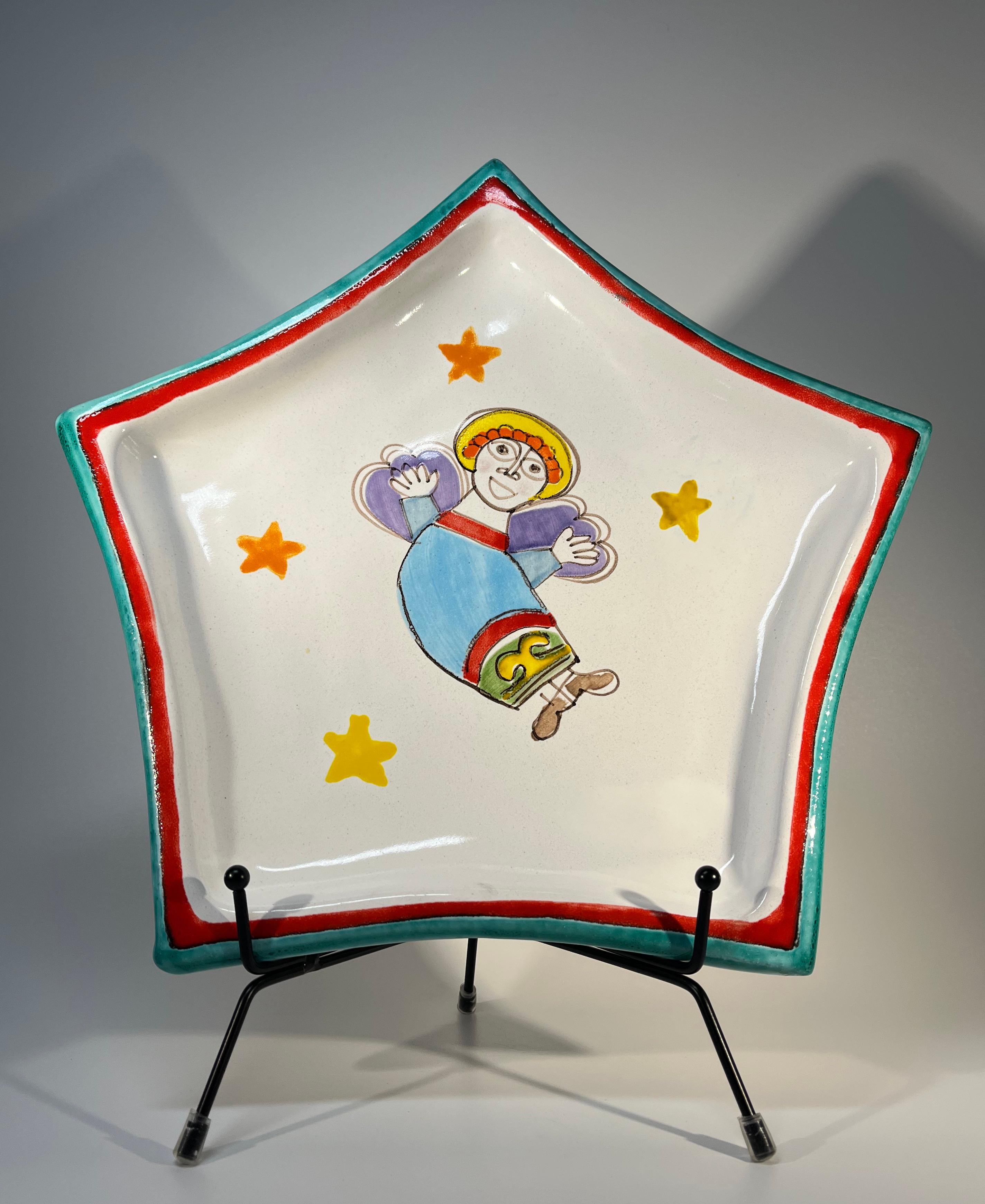 Star shaped ceramic hand painted platter by DeSimone, Italy
A glorious and uplifting hand painted angel flies amongst stars on this joyous piece
Circa 1960's
Signed DeSimone, Italy. Original De Sanctis, Roma, label
Height 1.25 inch, Width 11.5 inch,