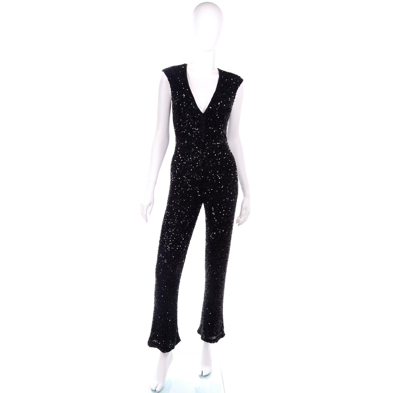 This vintage sleeveless black evening jumpsuit is literally sparkling with intricately hand sewn beads and sequins! This would be a great evening dress alternative for any holiday party or special evening event. This deep V neck jumpsuit is fully