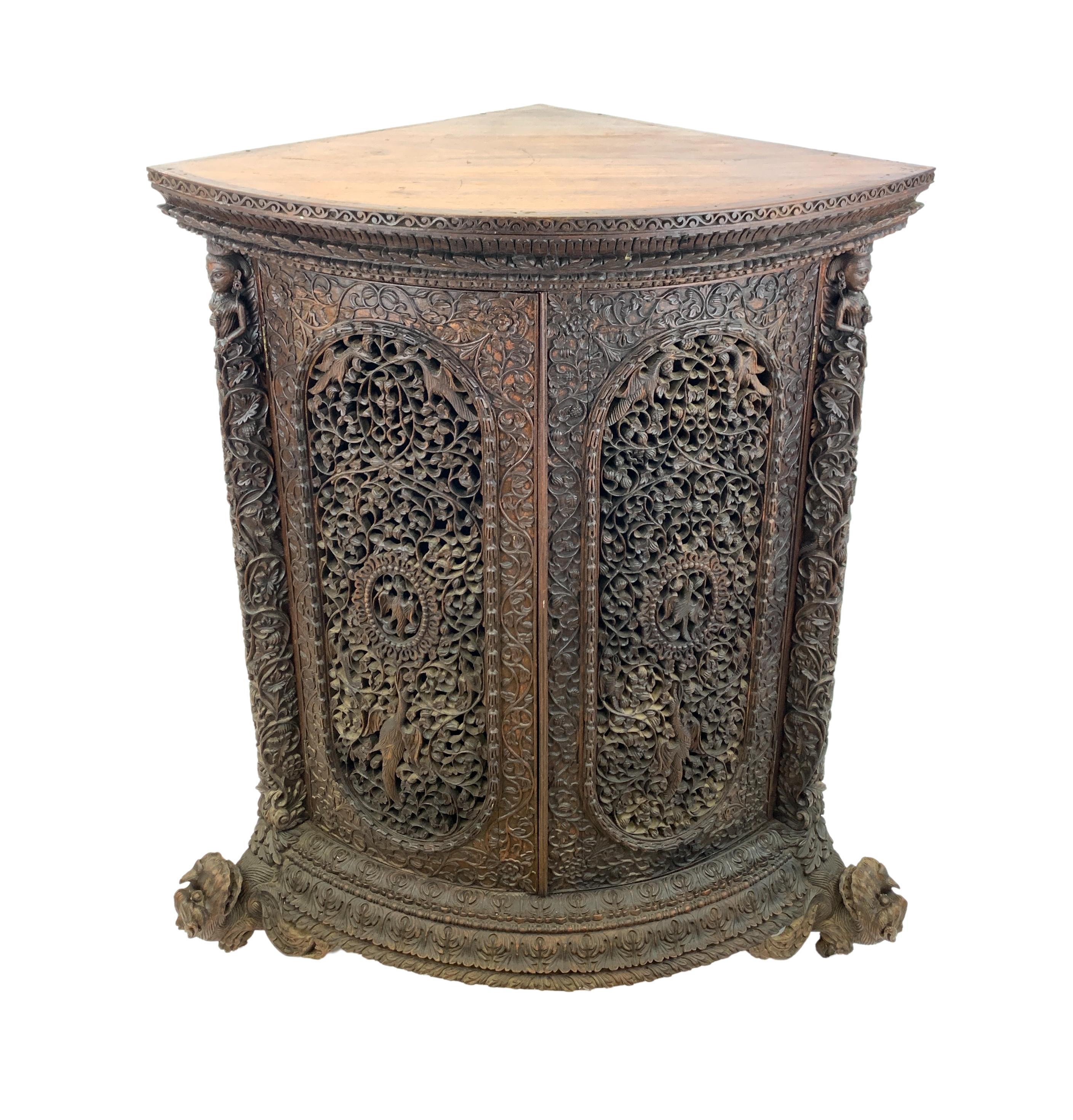Impressive Anglo Indian carved hardwood corner cabinet, deeply carved with trailing vines and wonderful different variety of bird. 
 