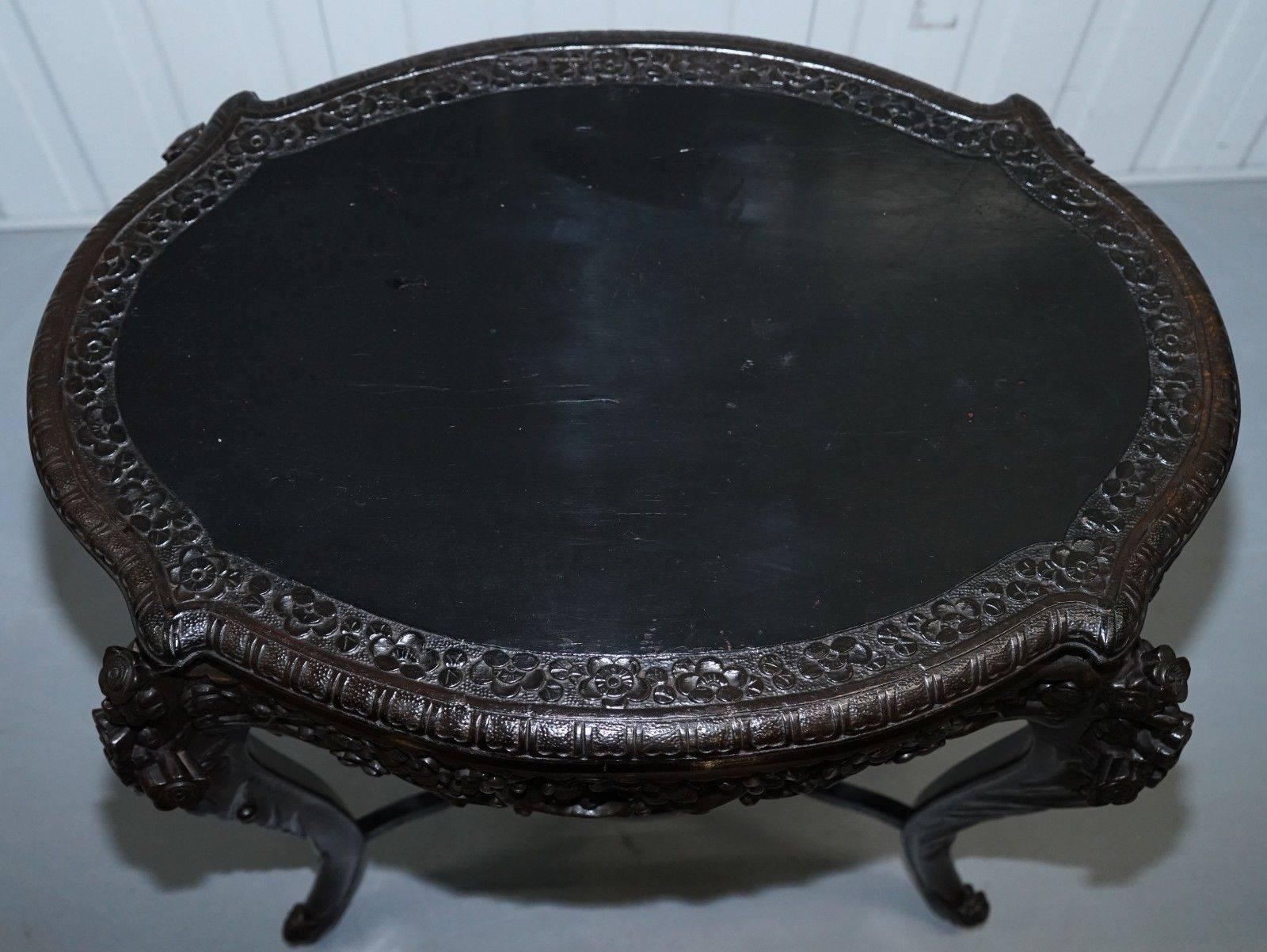 We are delighted to offer for sale this stunning heavily carved and black lacquered Chinese export oval centre table, circa 1900.

A very good looking and well made piece, carved all around the trim and tops of the legs with floral leaf foliage