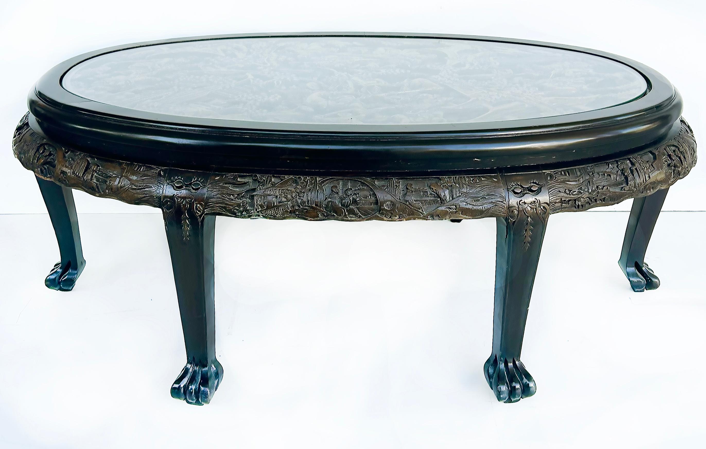 Heavily Carved Chinoiserie Oval Coffee/Cocktail Table with Inset Glass Top 

Offered for sale is a heavily carved chinoiserie oval coffee/cocktail table with an inset glass top and six tapering legs with claw feet.  The top is beautifully and deeply