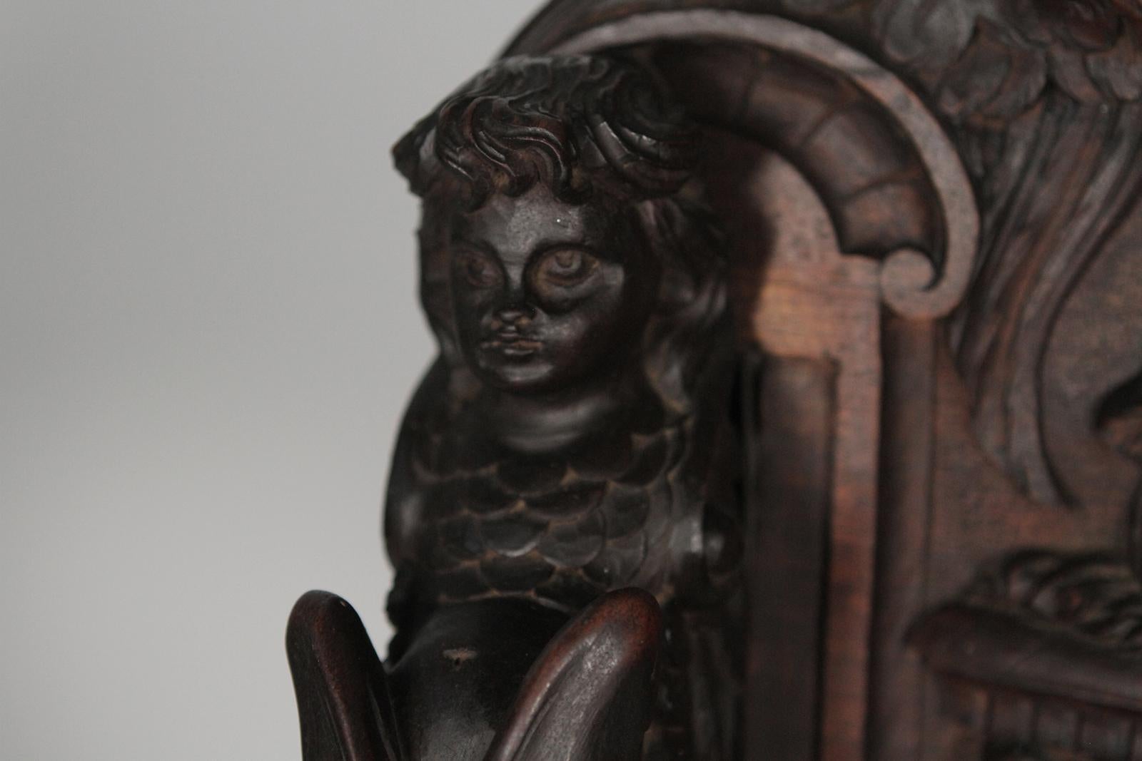Heavily Carved Figural Campaign Chair, Lions, Cherubs, Dragons, circa 1890 In Excellent Condition For Sale In Lambertville, NJ