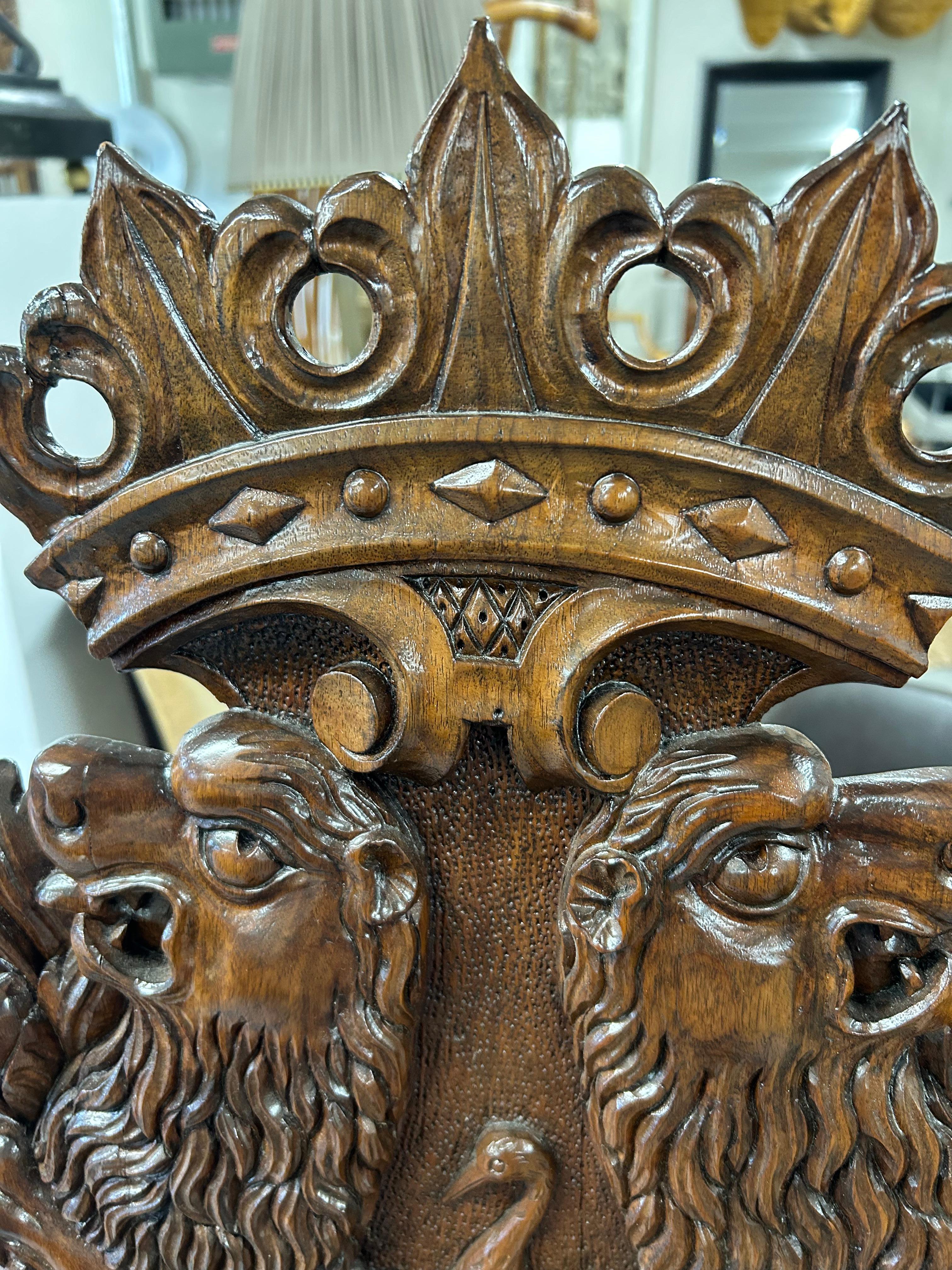 Beautiful ornately carved Italian Sgabello hall chair having amazing figural details including face on the base, lions and bird on the front, gorgeous smooth back and grain to the wood.