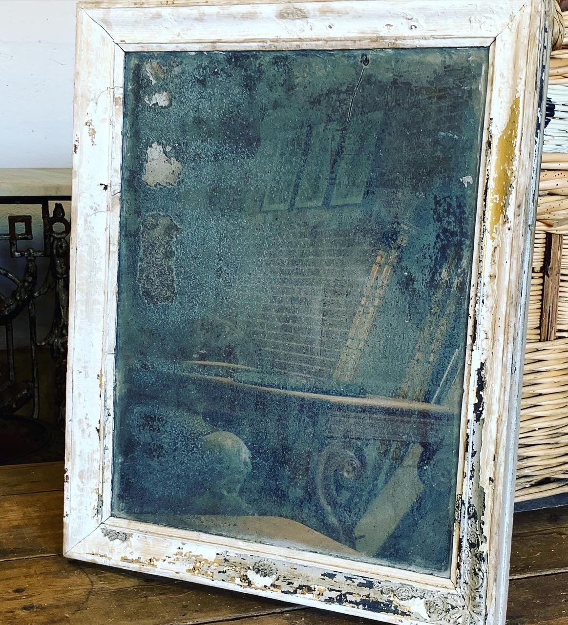 A 19th century French mirror with a beautiful heavily distressed glass plate. Can be hung portrait or landscape.