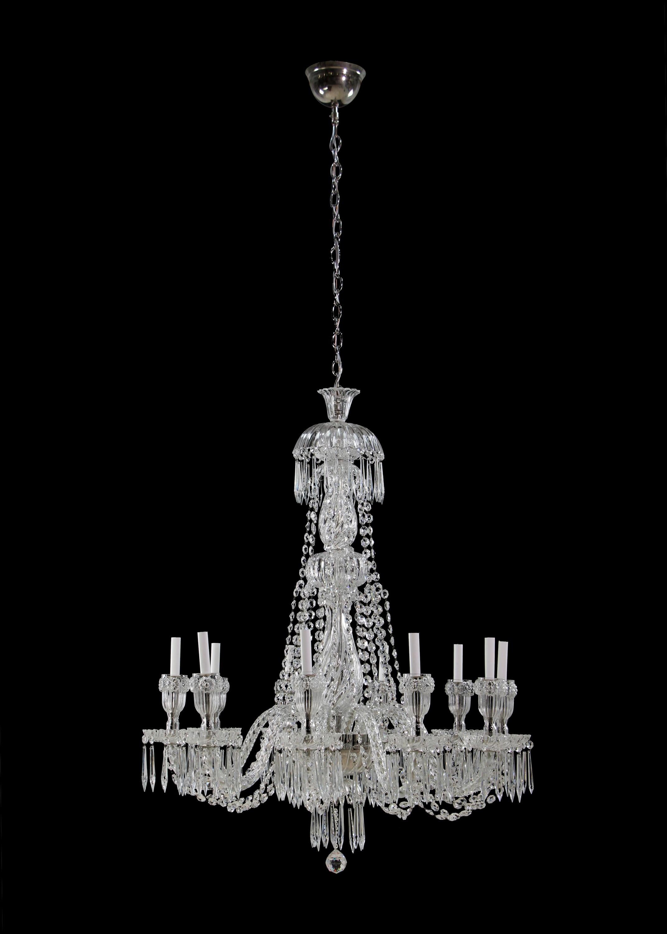 20th century over the top 12 light crystal chandelier. Features braided crystal arms, crystal swags looping from arm to arm, needle crystals dripping throughout and mirrored ceiling canopy. Takes 12 standard chandelier light bulbs. Cleaned and
