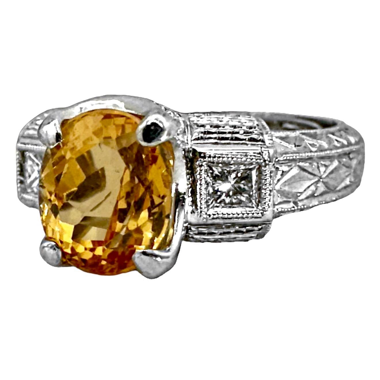 Ein leuchtender, ovaler Goldtopas von 3,11 Okt. ist in der Mitte dieses Rings im antiken Stil mit einer Zacke gefasst und wird auf beiden Seiten von einem Diamanten im Prinzessschliff flankiert, der von scharfen, gemahlenen Kanten eingefasst ist.