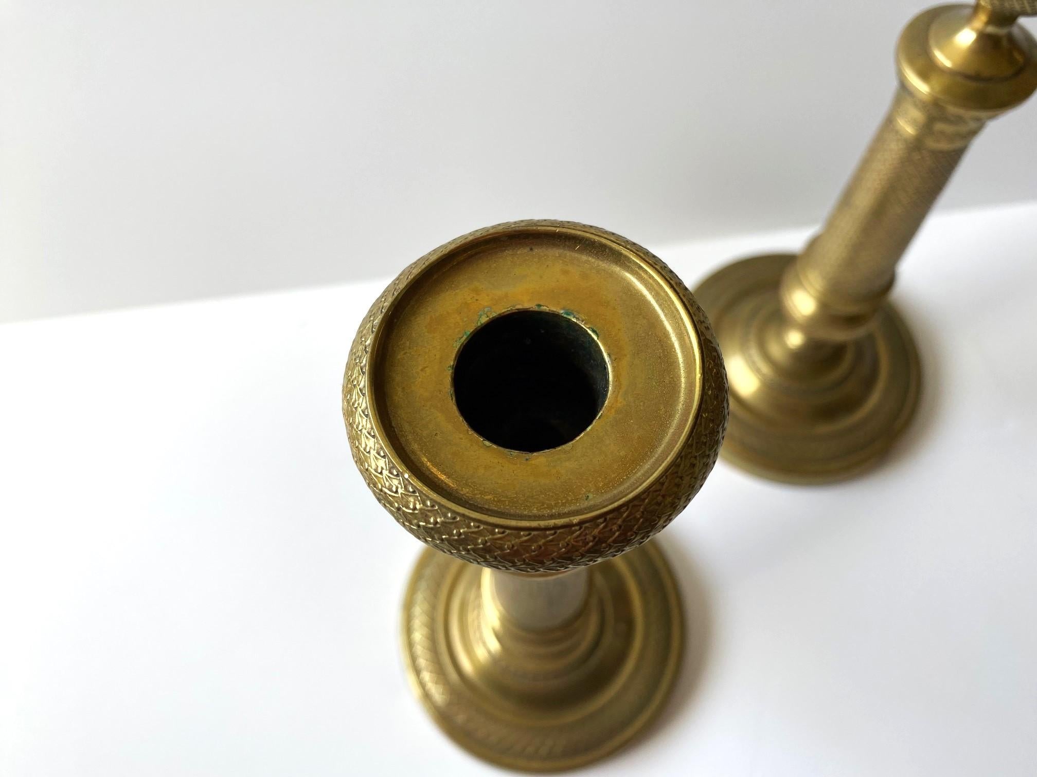 A pair of English brass candlesticks with a heavy Morrocan influence. Profusely engraved in super fine detail. Removable tops.  
