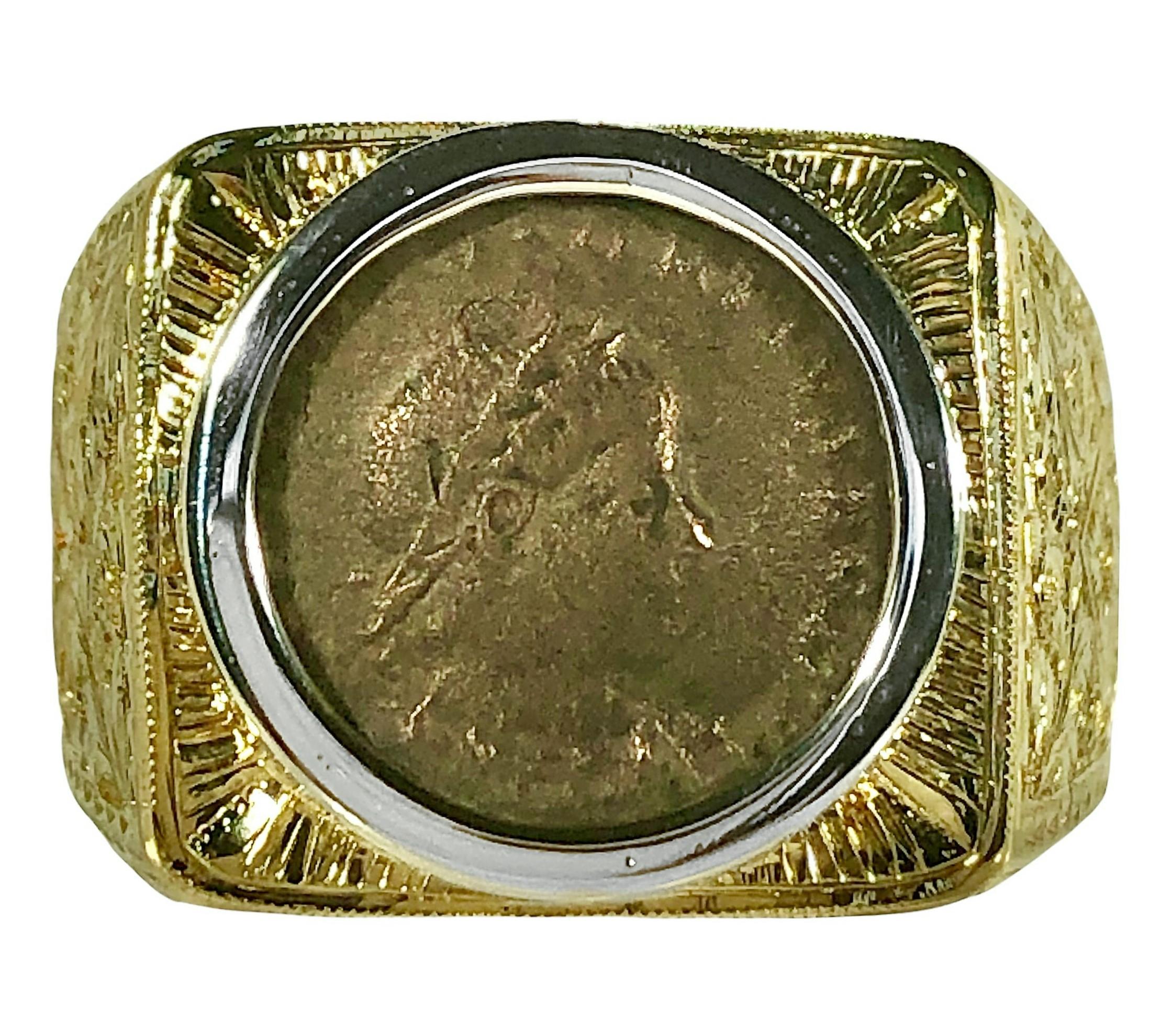This vintage men's ancient coin ring is unique in that all of the intricately engraved surfaces were crafted entirely by hand. At it's center is an authentic ancient bronze coin set securely in an 18k white gold mill edged bezel. This center piece
