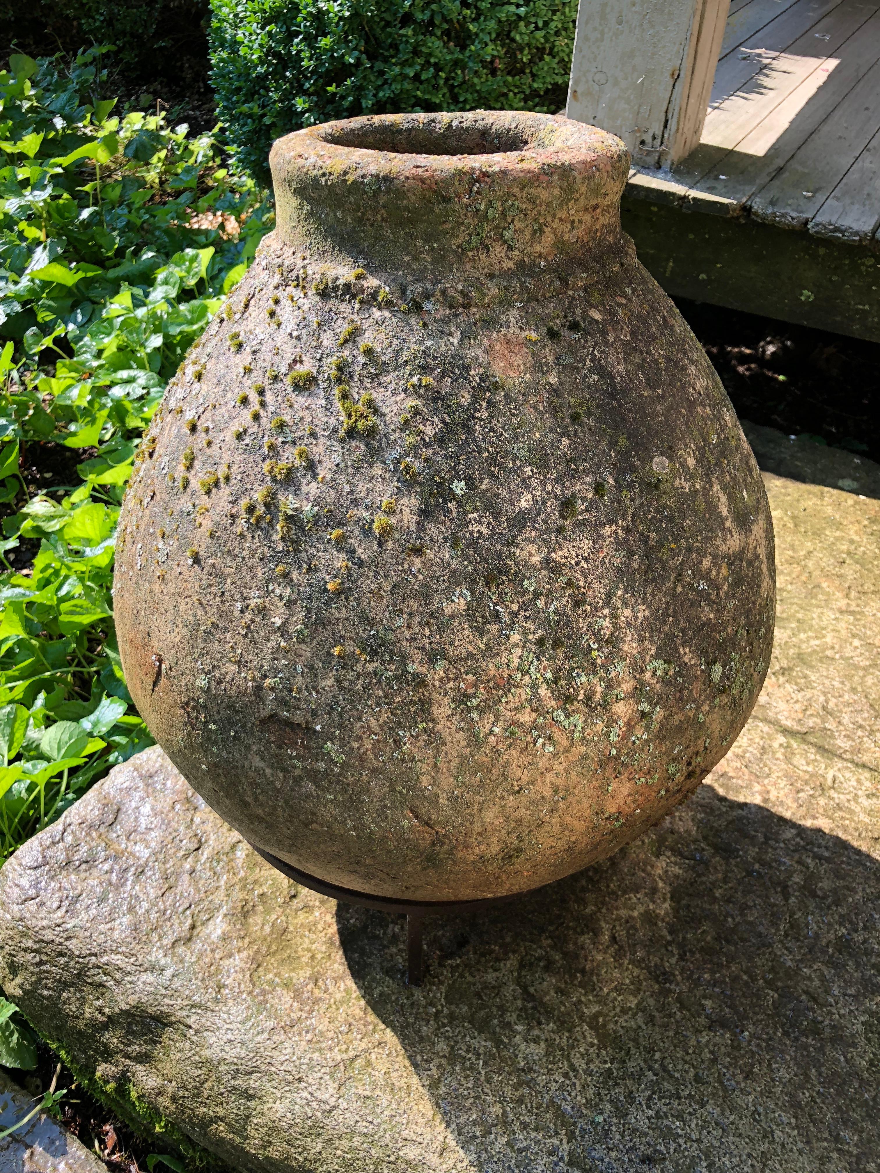 This lovely pot looks like terracotta, but is actually made of cast stone with a terracotta finish. It has a heavily-lichened surface with beautifully mossing that will continue to grow as long as the pot is placed in a damp and shady spot. It