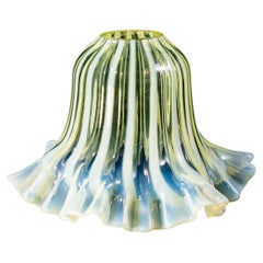 A pleated Vaseline shade, consisting of alternating stripes and a ruffled rim.