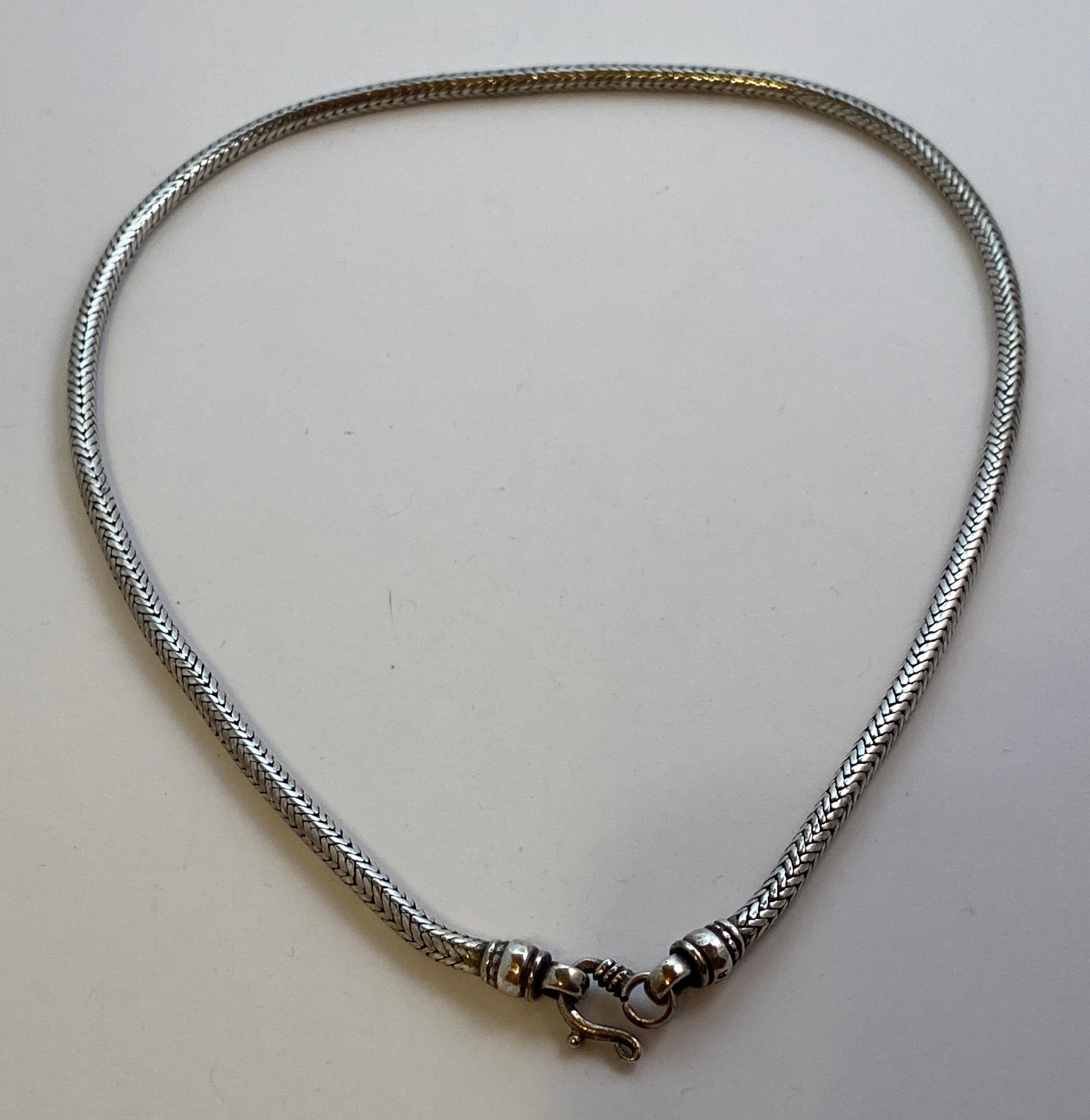 Heavily smooth snake-link sterling silver necklace has the maker's mark: RA 
Total length measures 18 2/8 inches, circumference measures 2/8 of a inch. Made in US