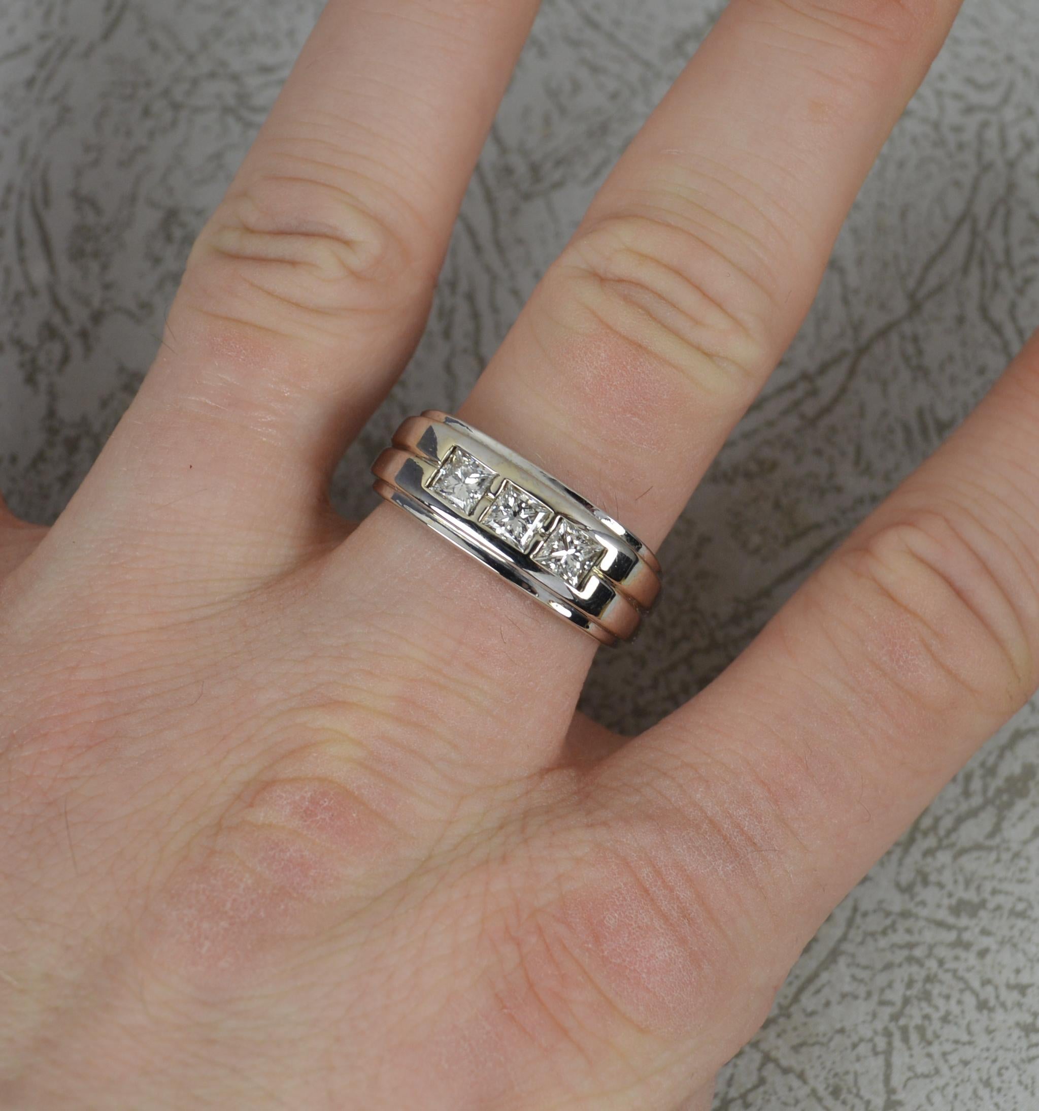 A superb quality natural diamond ring.
Solid 14 carat white gold example.
Designed with three natural, princess cut diamonds to total 0.9 carat as confirmed to shank.
3.75mm diameter diamonds, very clean bright and sparkly. 8.2mm wide