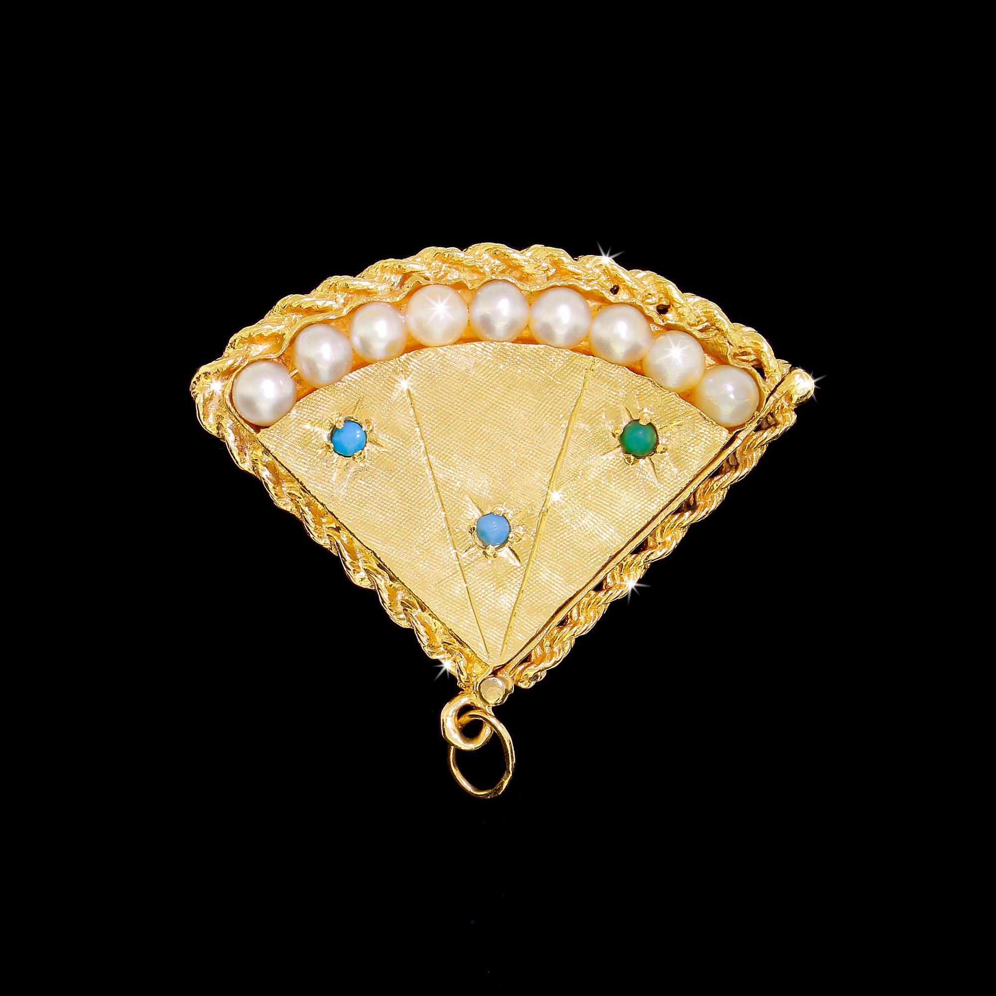 Large, heavy and quite unusual. This double-sided 14K solid gold fan-shaped locket features pearls and Persian turquoise stone accents. Beautiful detailing and superb craftsmanship indicate this pendant is the work of a master. Every surface has
