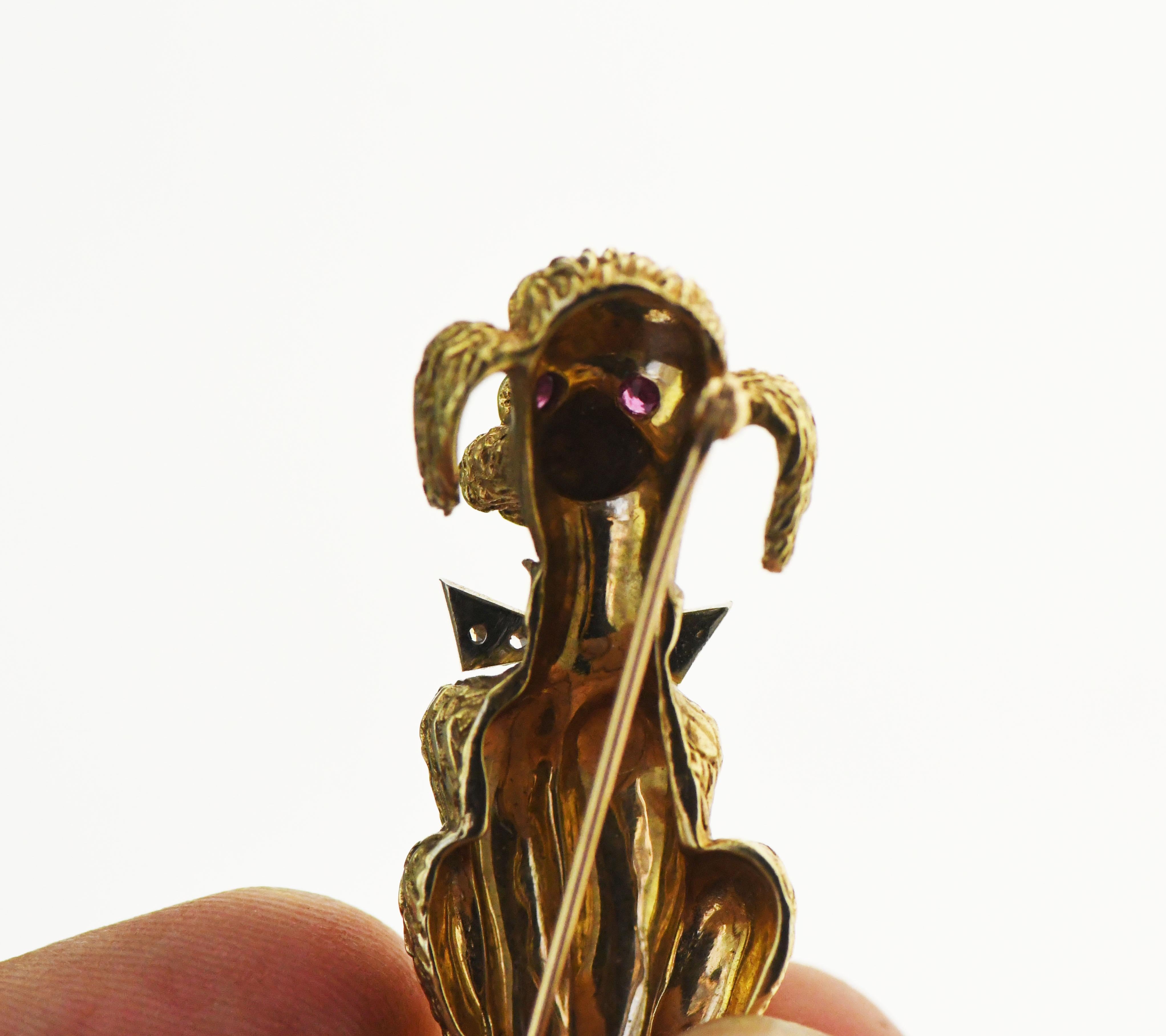 14k Yellow Gold Poodle Pin Pendant with Ruby Eyes and Diamond Bowtie. Nice and Heavy. The Diamonds are single cut. Size 2mm. The rubys are also 2mm. Piece is not marked but has been tested as 14k. has a stonger yellow like 18k but did not test as