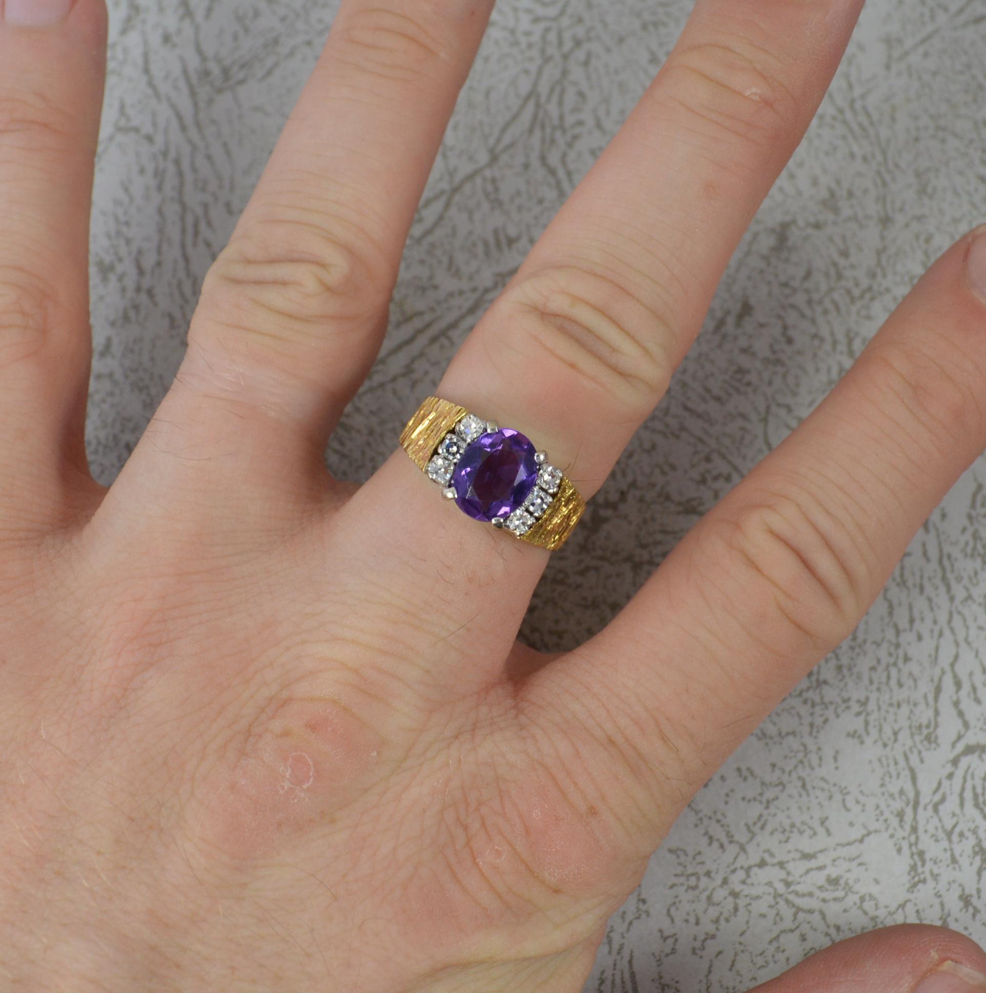 A beautiful Amethyst and Diamond ring.
Solid 18 carat yellow gold shank with bark finish to shoulders and platinum claw settings for the stones.
7mm x 9mm oval cut amethyst with three round, eight cut diamonds to each side.
A heavy vintage