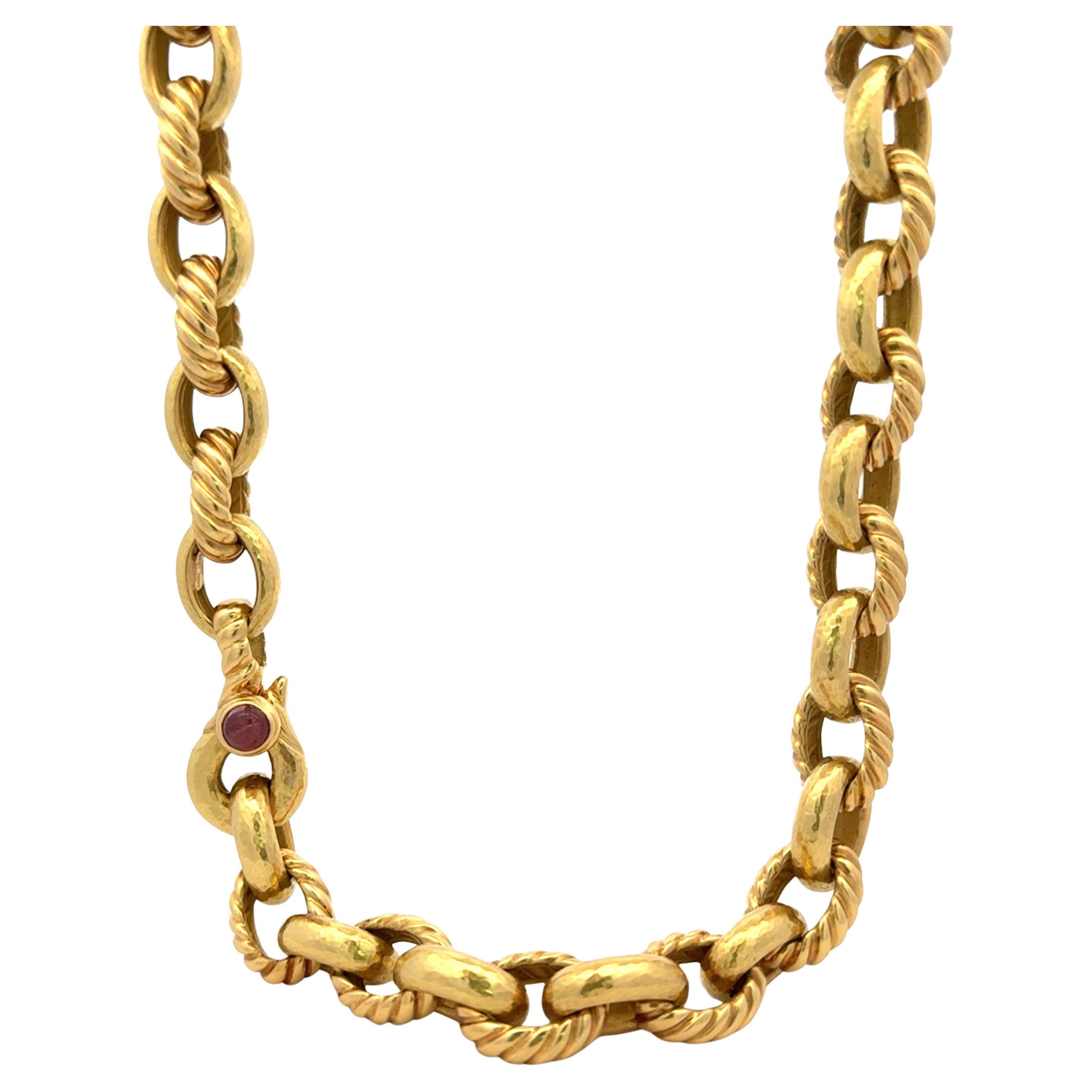 Heavy 18 karat yellow gold necklace featuring alternating braided and hammered design links with a Cabochon Ruby on the clasp, 94.7 grams. A great piece to own. 

Message for more videos & pictures if needed.
More beautiful link necklaces &