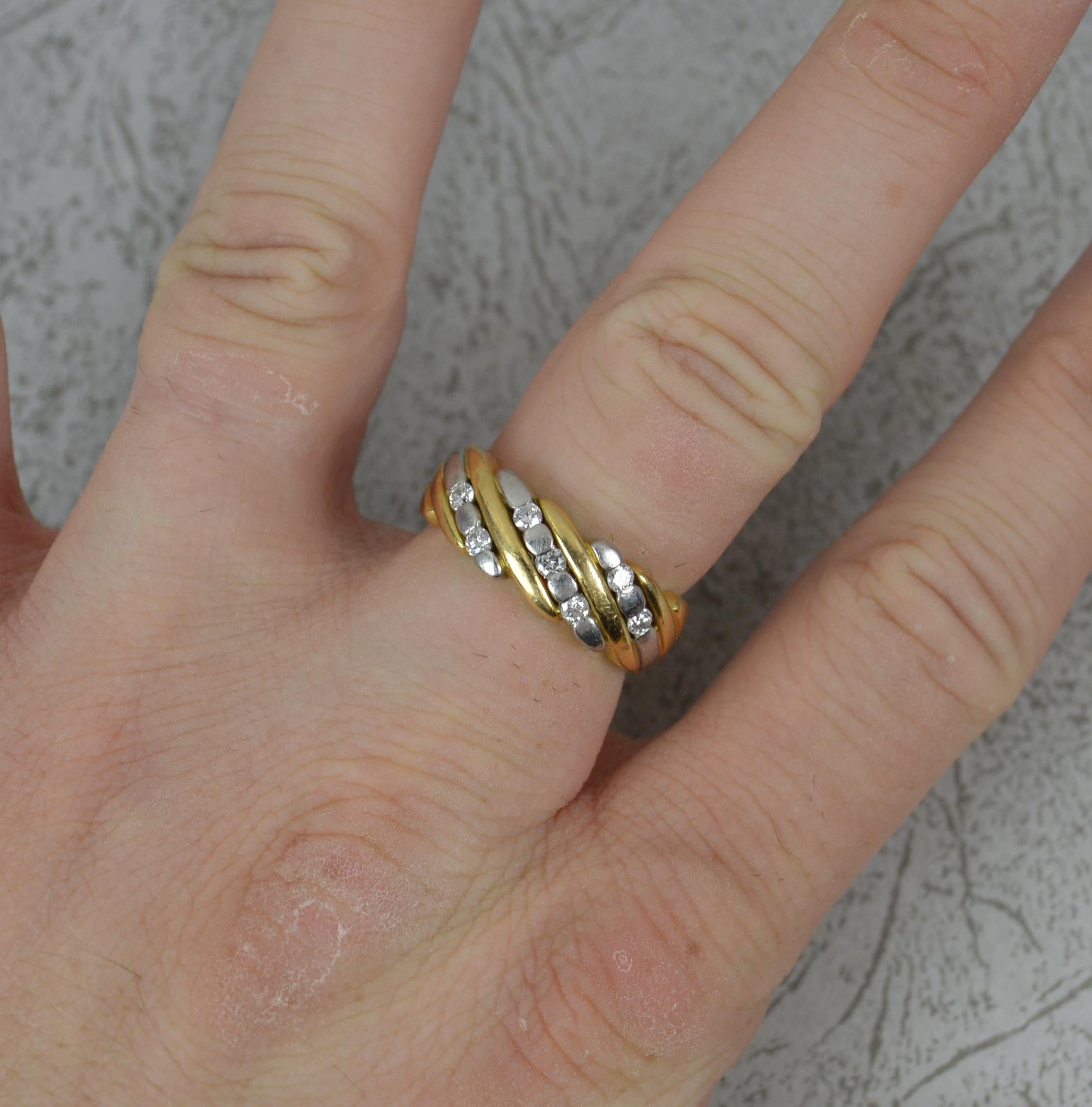 A heavy and solid band.
18 carat yellow gold and 950 grade platinum example.
The head set with seven round brilliant cut diamonds, 18mm spread of stones, 7mm wide band to front.

CONDITION ; Excellent. Crisp pattern. Clean, solid band. Crisp