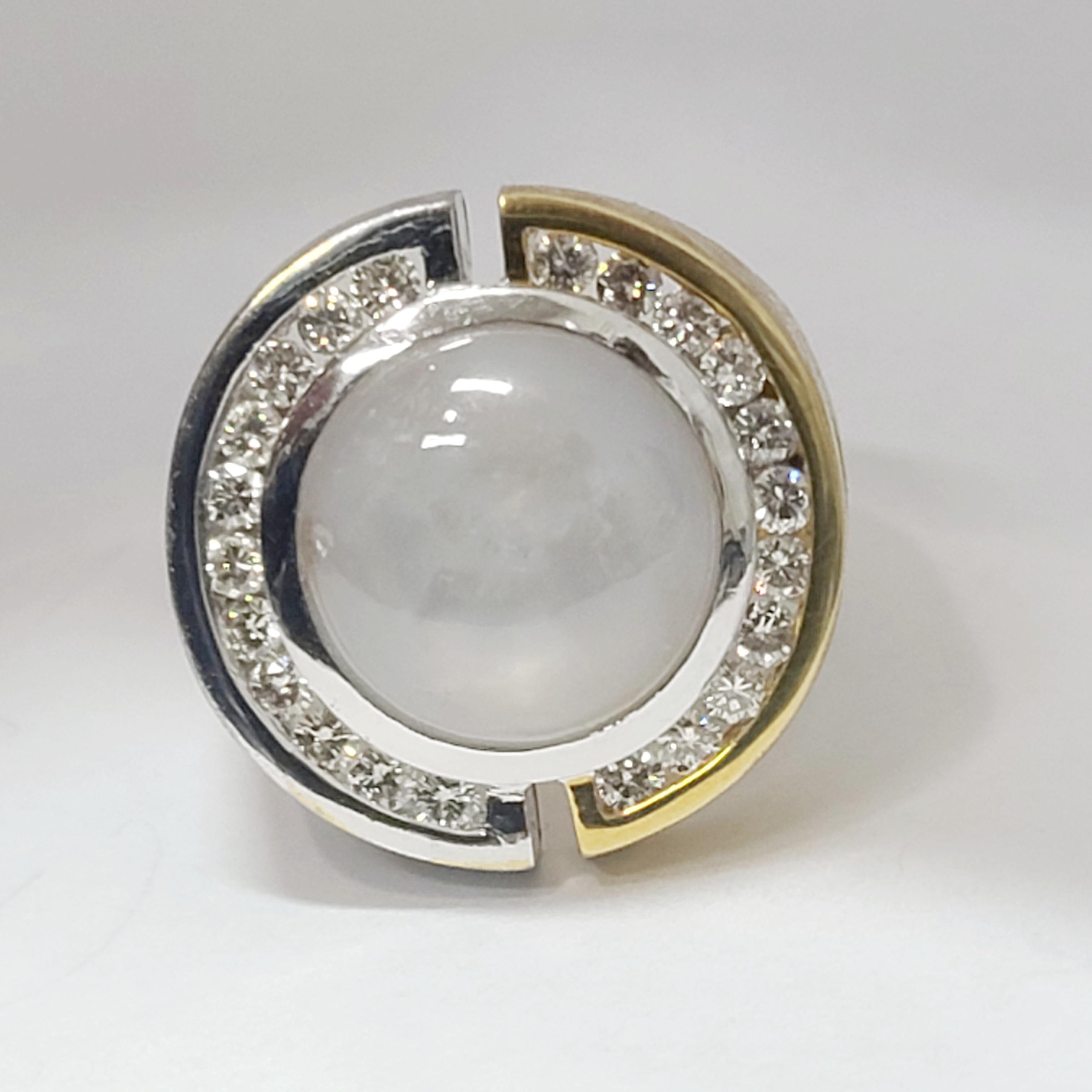 Amazing custom made JAMAR signed 18k folded yellow and white gold having a damascus type wood grain effect to the metal.  It is split down the middle to creat a ying yang type of effect.  The center cabochon is a natural grey star sapphire with a