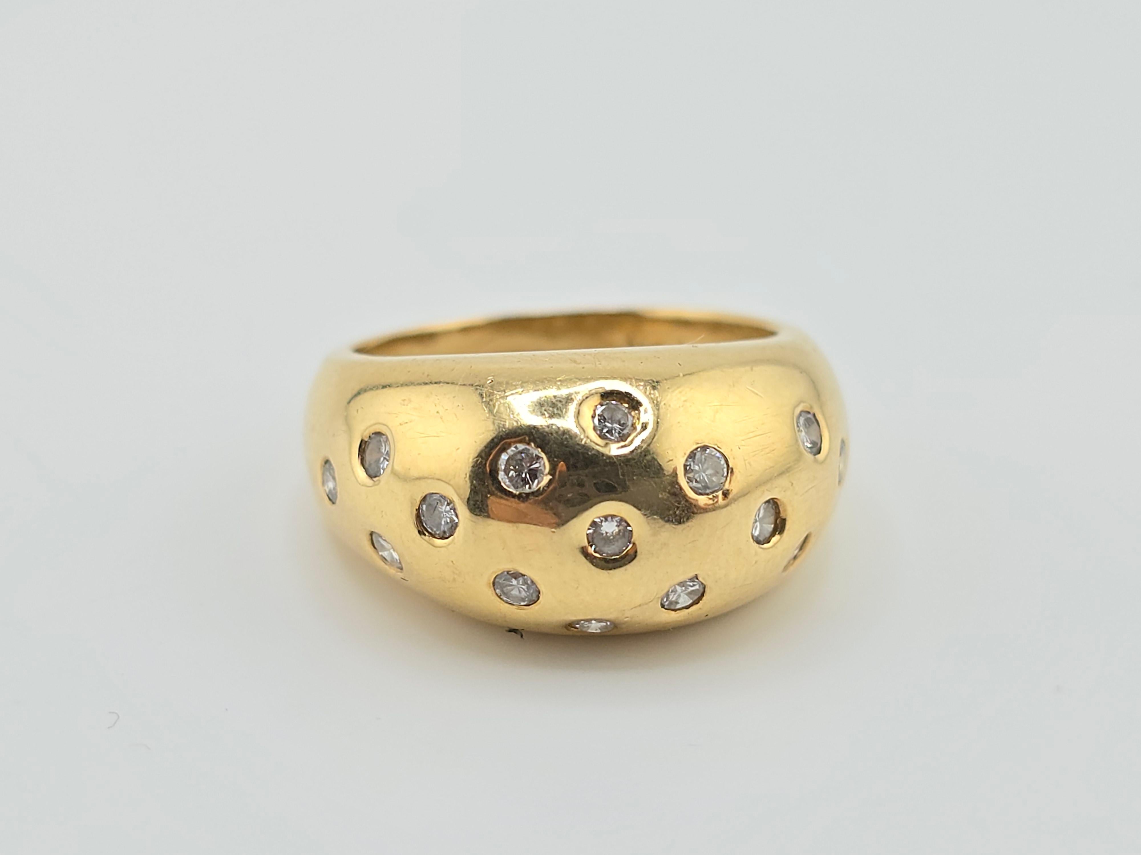 This is a very heavy gorgeous diamond and 18 karat yellow gold ring. It has many little round diamonds all around the ring. The quality of the diamonds are very beautiful ranging from VS to SI Clarity with colors of GHI. The weight of the ring is