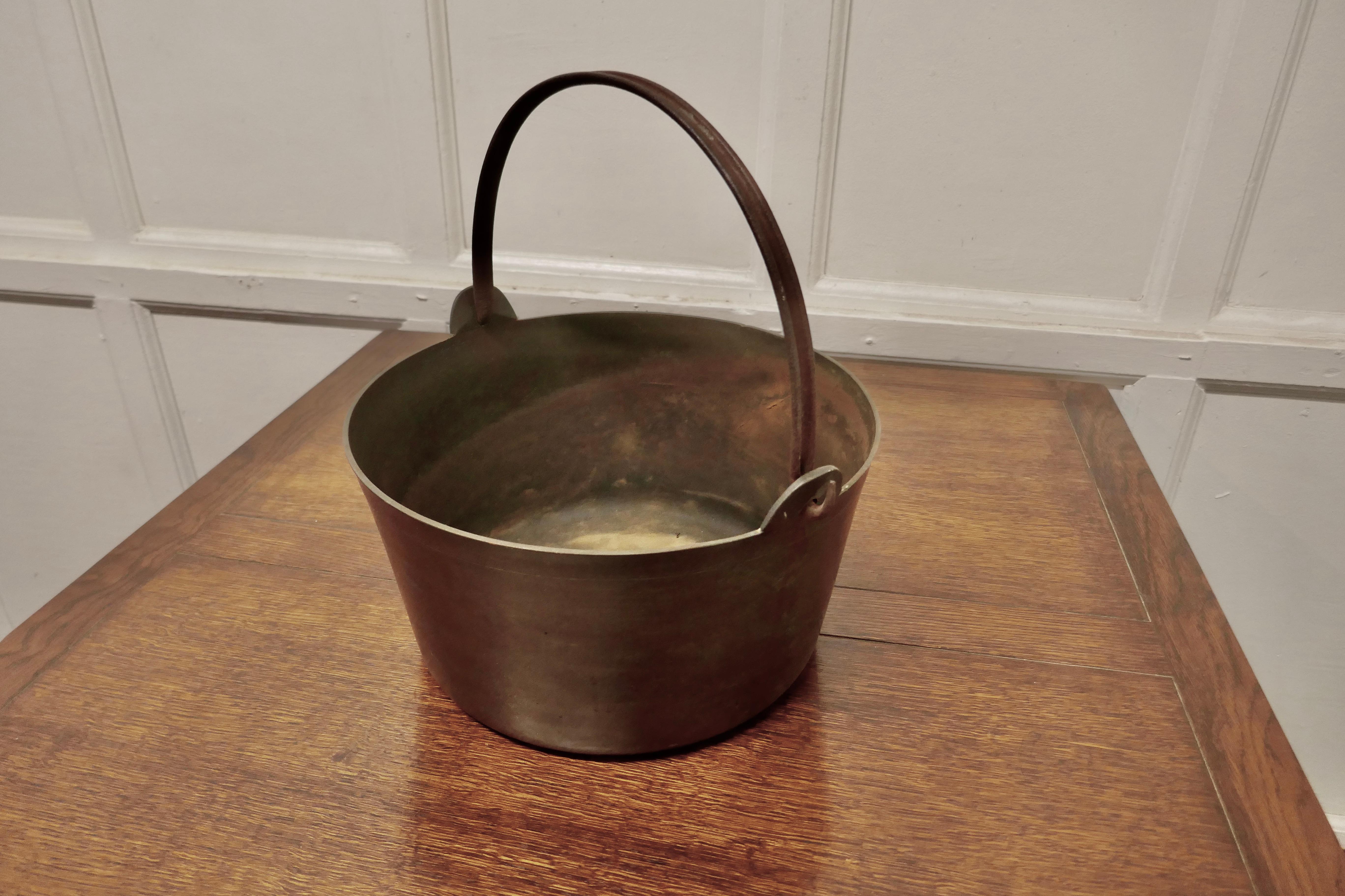 Heavy 19th Century Brass Preserving or Jam Pan 

A superb piece of social history and a must for the kitchenallia collector, this is a 19th century piece and very heavy it is in sound and very usable condition, it has a blacksmith made iron swing