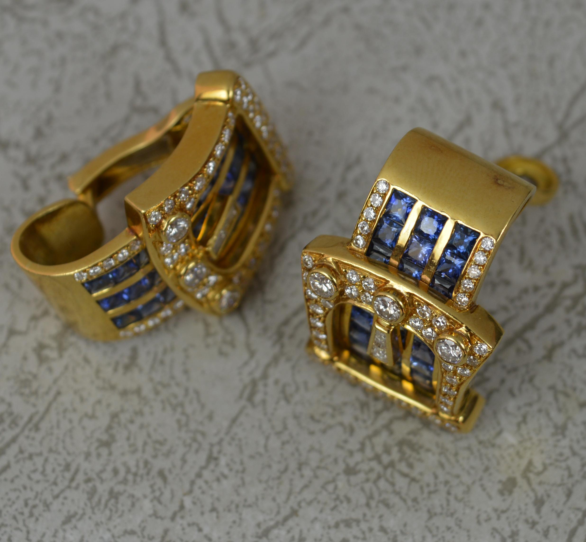 A superb pair of Sapphire and Diamond cluster earrings.
Solid 18 carat yellow gold. Exceedingly heavy.
The buckle designs are set with many round brilliant cut diamonds, Vs clarity, g-h colour, 2.00 carats total. Set with three columns of princess