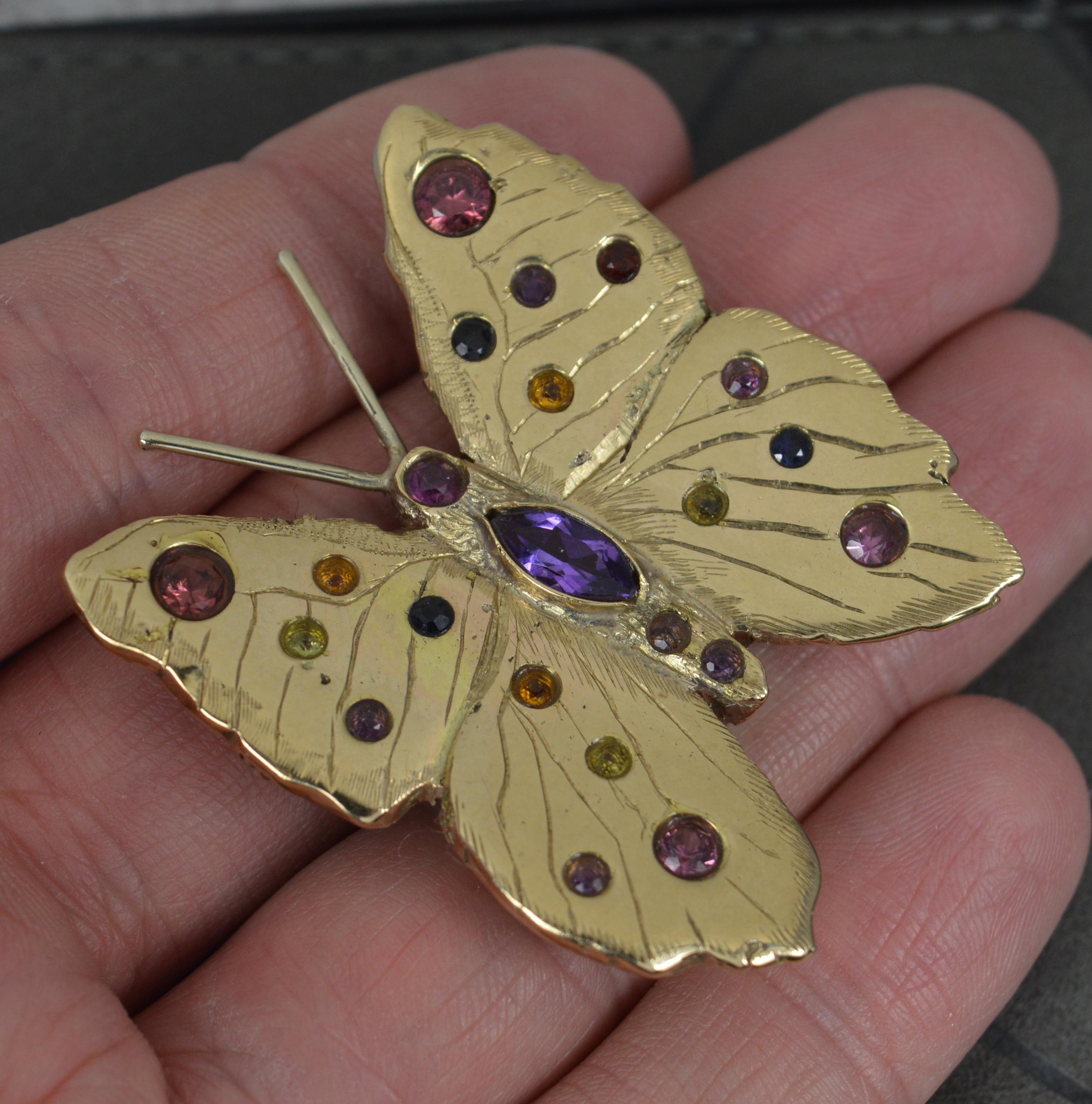 A very well made, heavy 9ct gold butterfly.
9 carat yellow gold.
Encrusted with many natural gemstones, various colours. Amethyst, tourmaline, citrine, sapphire etc.
CONDITION ; Excellent. Very crisp design. Well set, clean stones. Working brooch.