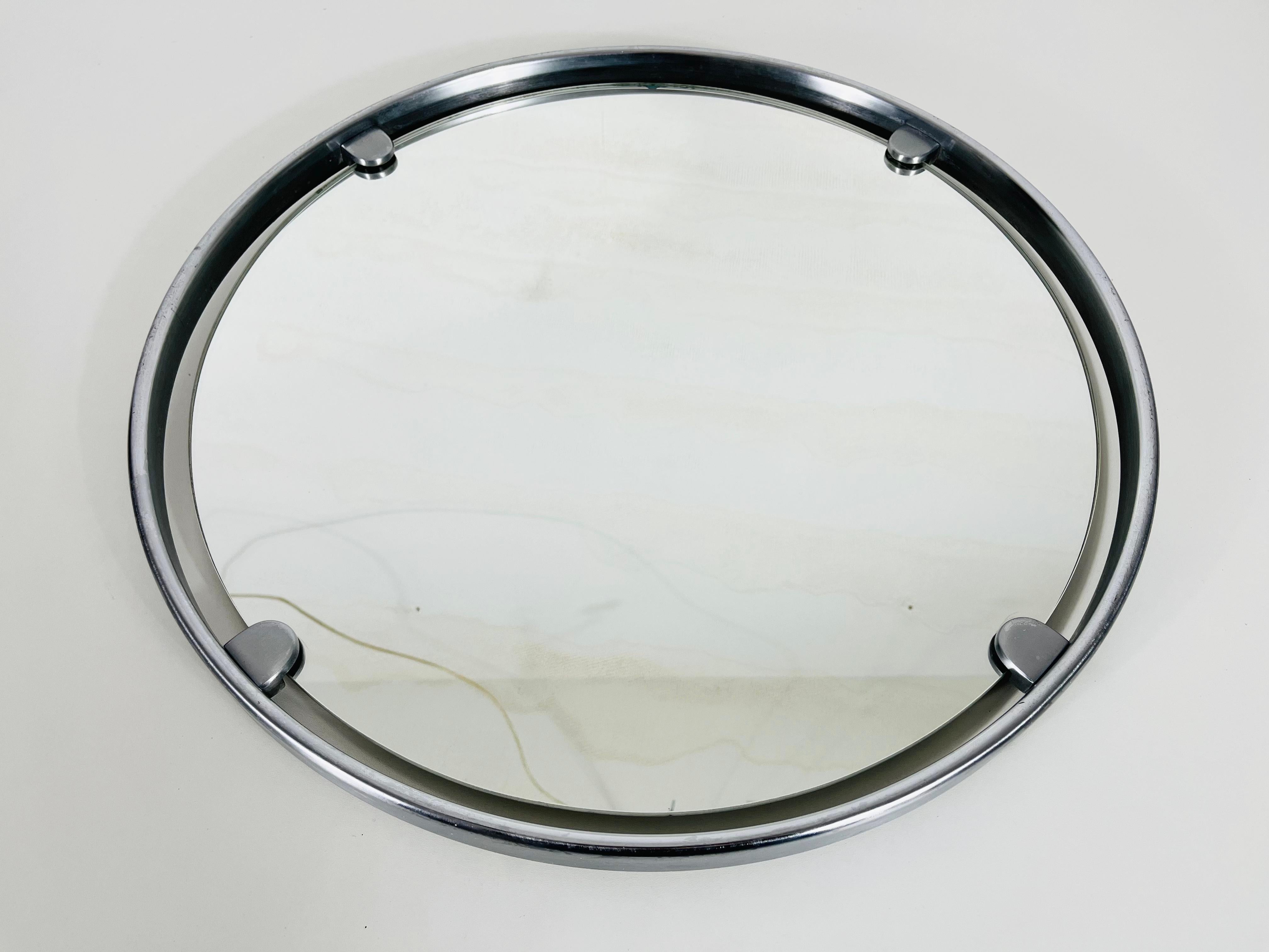 A heavy Hillebrand wall mirror from the 1960s made in Germany. The mirror has a round metal design. The aluminium made mirror is in a good vintage condition.

Free worldwide express shipping.