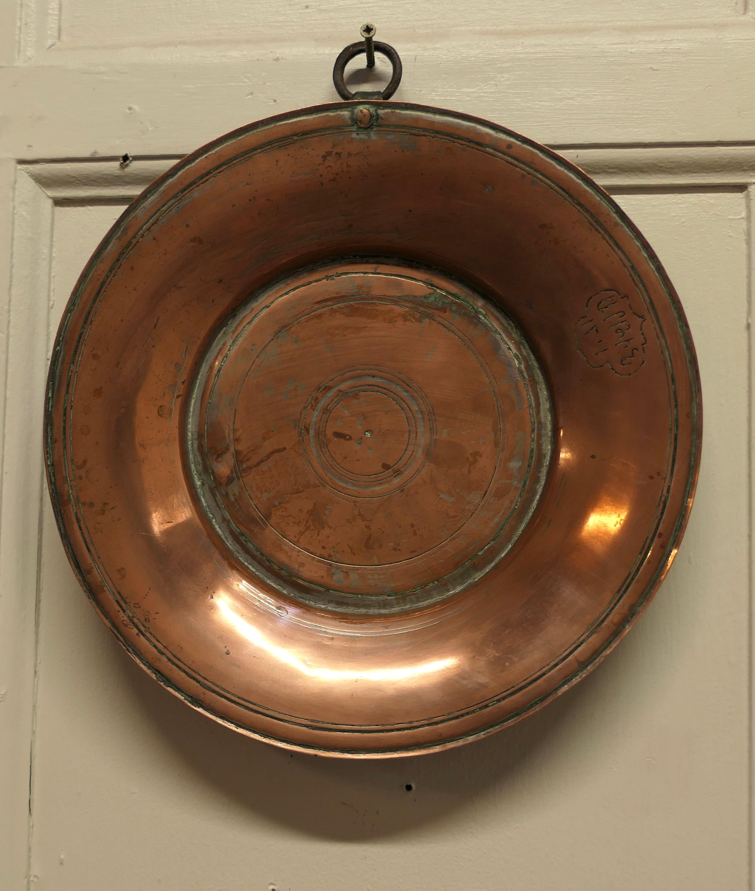 Heavy antique hand made copper plates

These are very heavy quality copper, they have thick bases and one has a hanging ring.
These were made in Asia in the 19th Century 
The large dish is 13” in diameter an the smaller is 10” in diameter