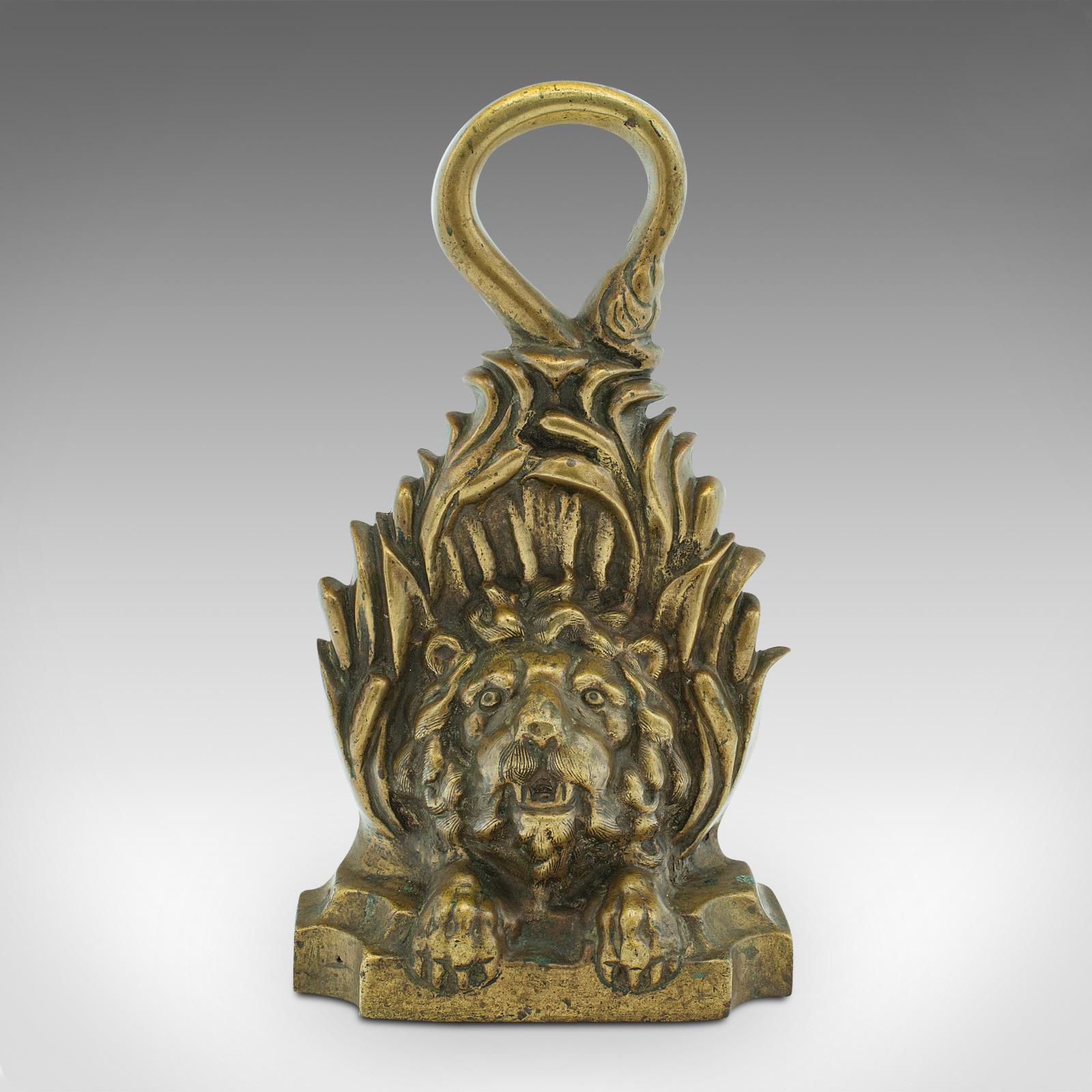 This is a heavy antique lion doorstop. An English, brass and lead decorative door keeper, dating to the early Victorian period, circa 1850.

Delightfully substantial stopper graced with an abundance of character
Displays a desirable aged patina