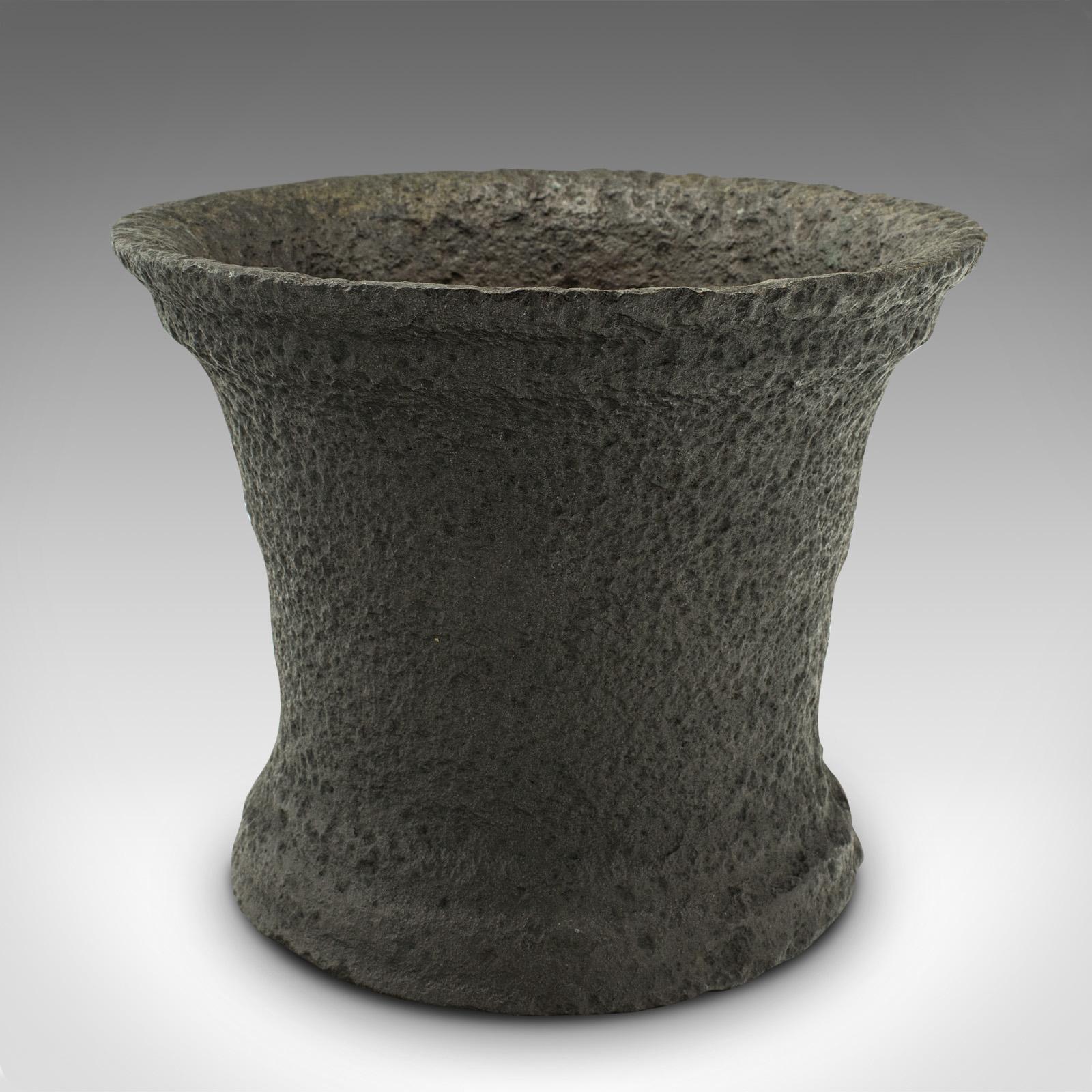 This is a heavy antique mortar. An English, cast iron planter pot, dating to the mid Georgian period, circa 1750.

Of superb weight with an appealing weathered appearance
Displays a desirable aged patina and in good order
Robust cast iron