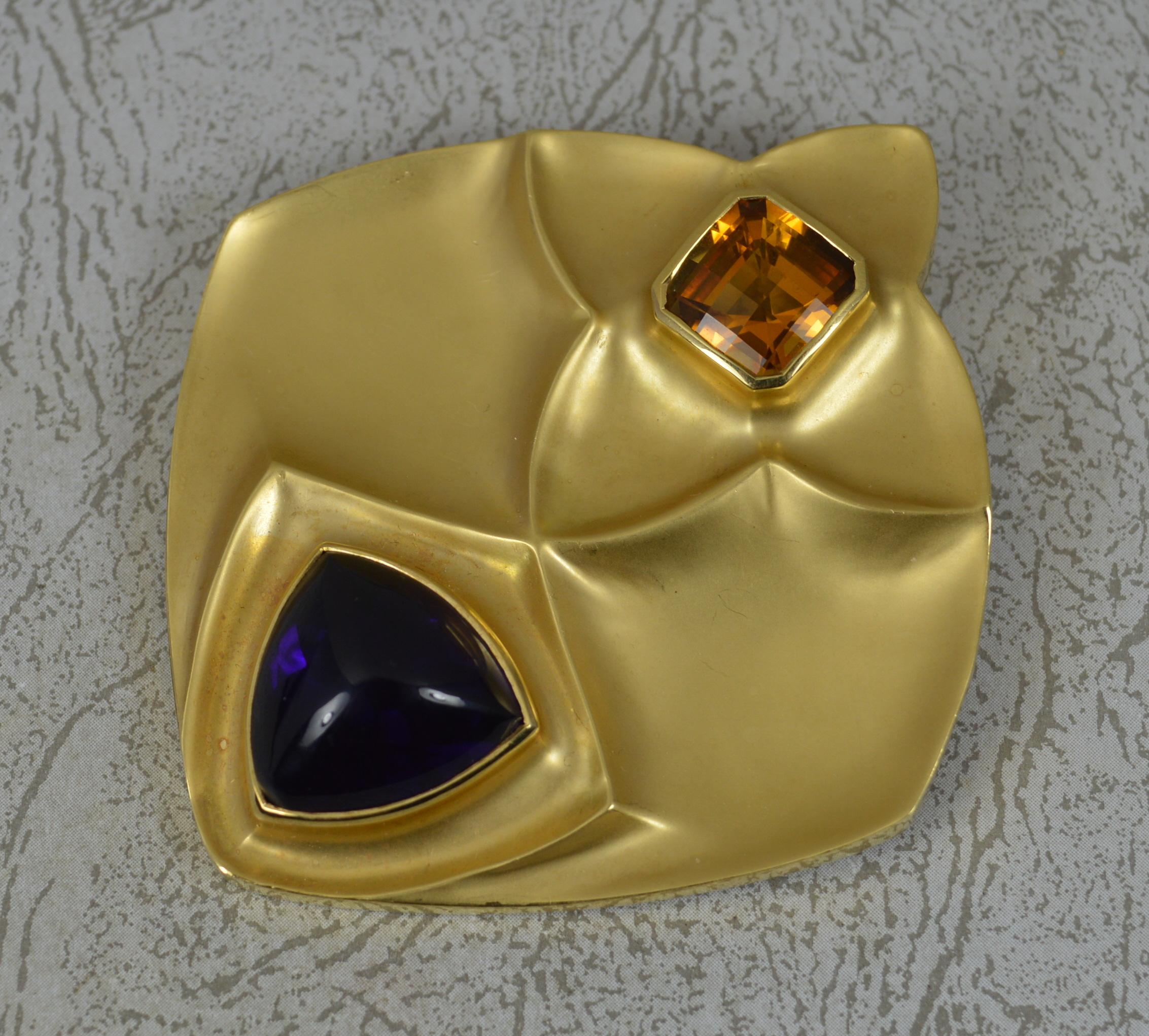 A stunning Boodles designer brooch.
Very heavy and solid example in 18 carat yellow gold.
Designed with a trillion shaped amethyst cabochon to top and facet cut top citrine of square shape below. 
A fine, stylish shape with both polished and matte