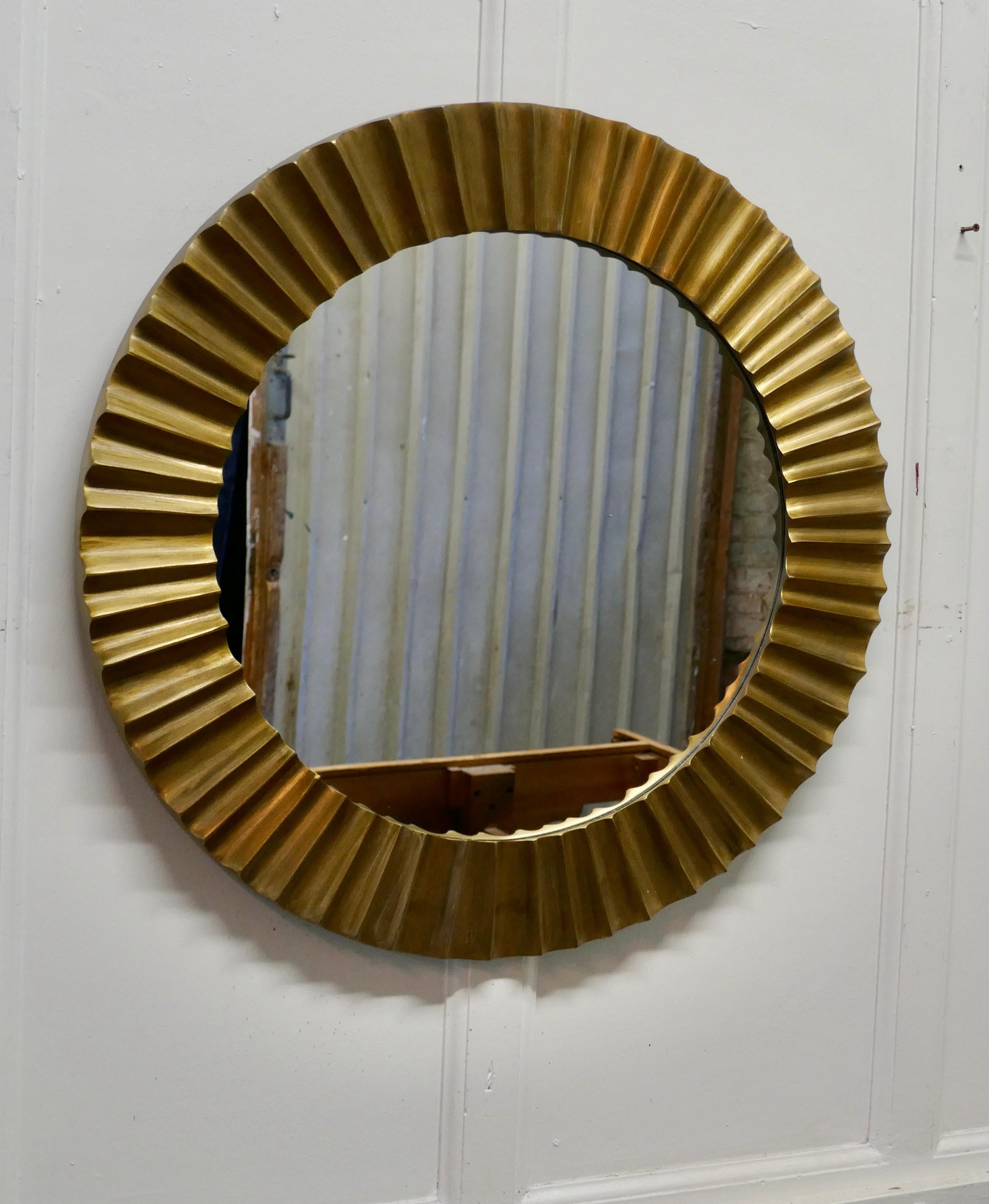 Heavy brass Art Deco odeon sunburst mirror

A superb piece, made in the last century, the mirror 4” wide frame is made in the Odeon style it is cast in solid brass and very heavy
The mirror is in good Vintage condition
The mirror is 28” in